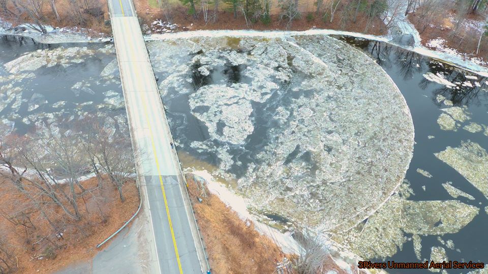 The ice disk broke apart as the current pushed it against the banks of the river.