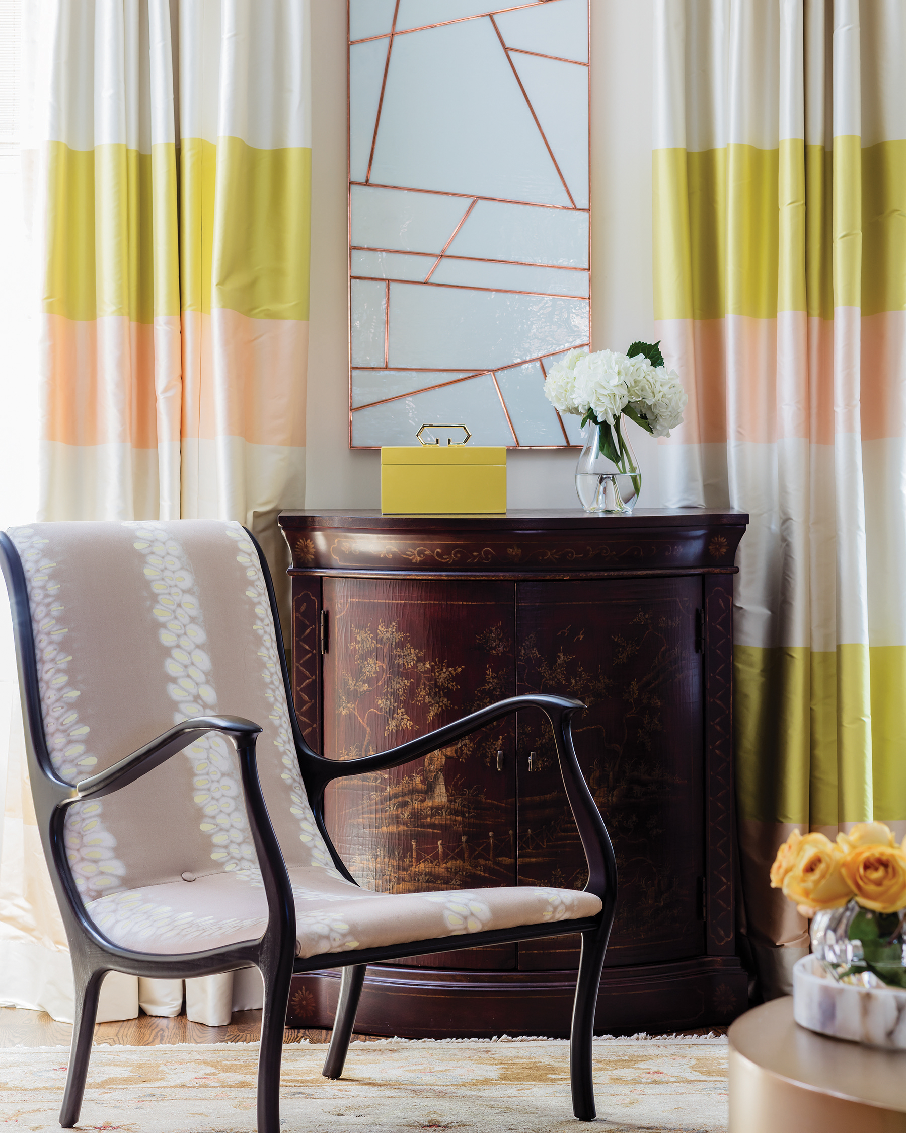 A cabinet in the living room was one of the few pieces from the Graovacs’ former home that they wanted to incorporate into their new place. The Julian Chichester wood armchair (which has a matching ottoman) is sculptural as well as comfortable, says Donohue.