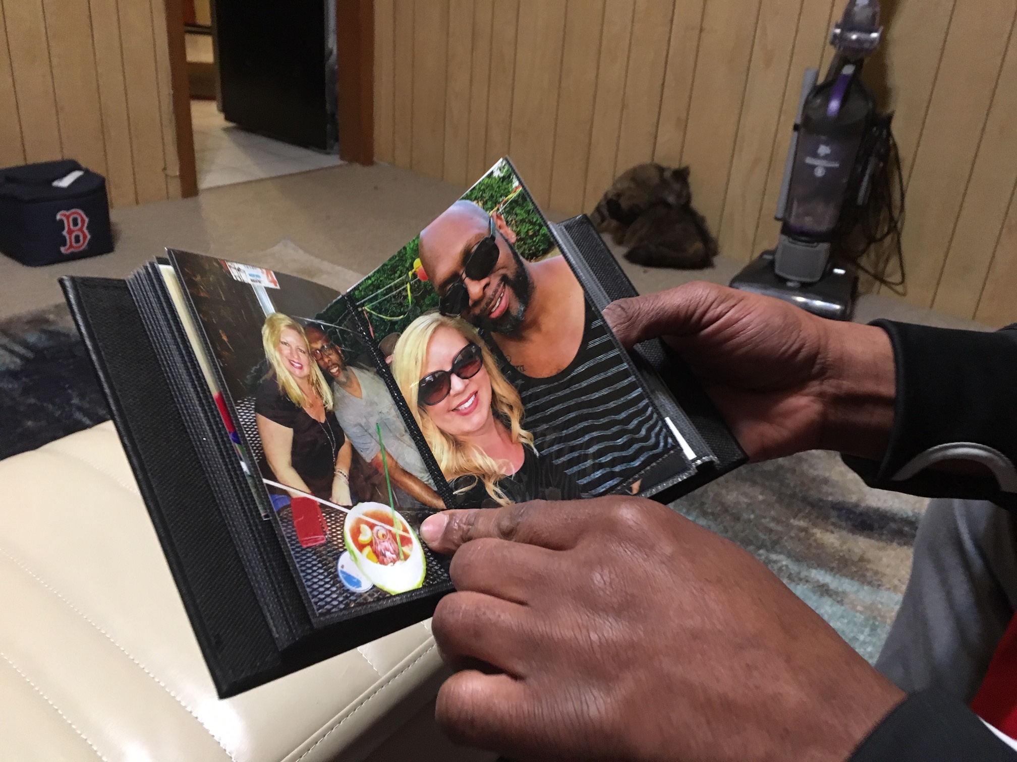 Kevin White flipped through a small photo album that Rena Fleury’s daughter put together after she died.