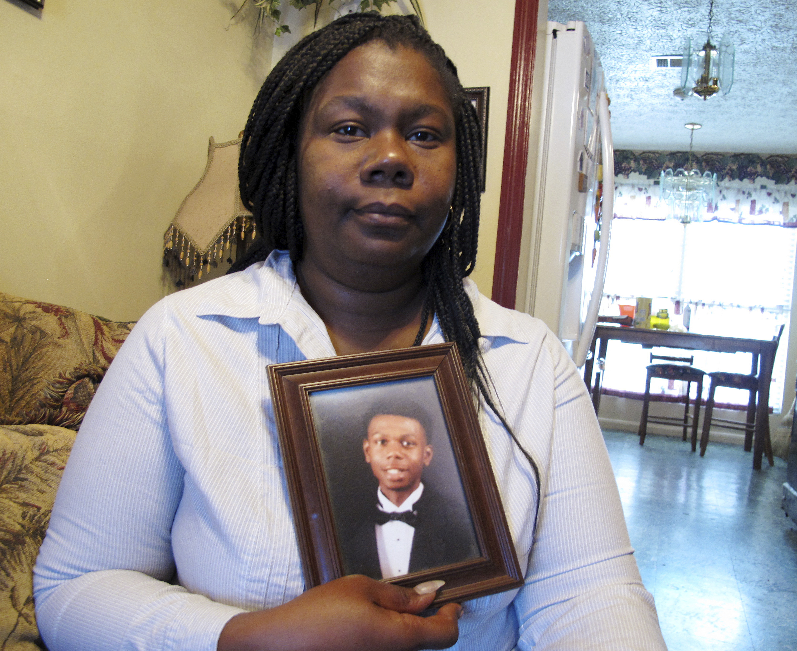 Jameillah Smiley held a framed photograph of her son, Ricky Boyd, at her home in Savannah, Ga.