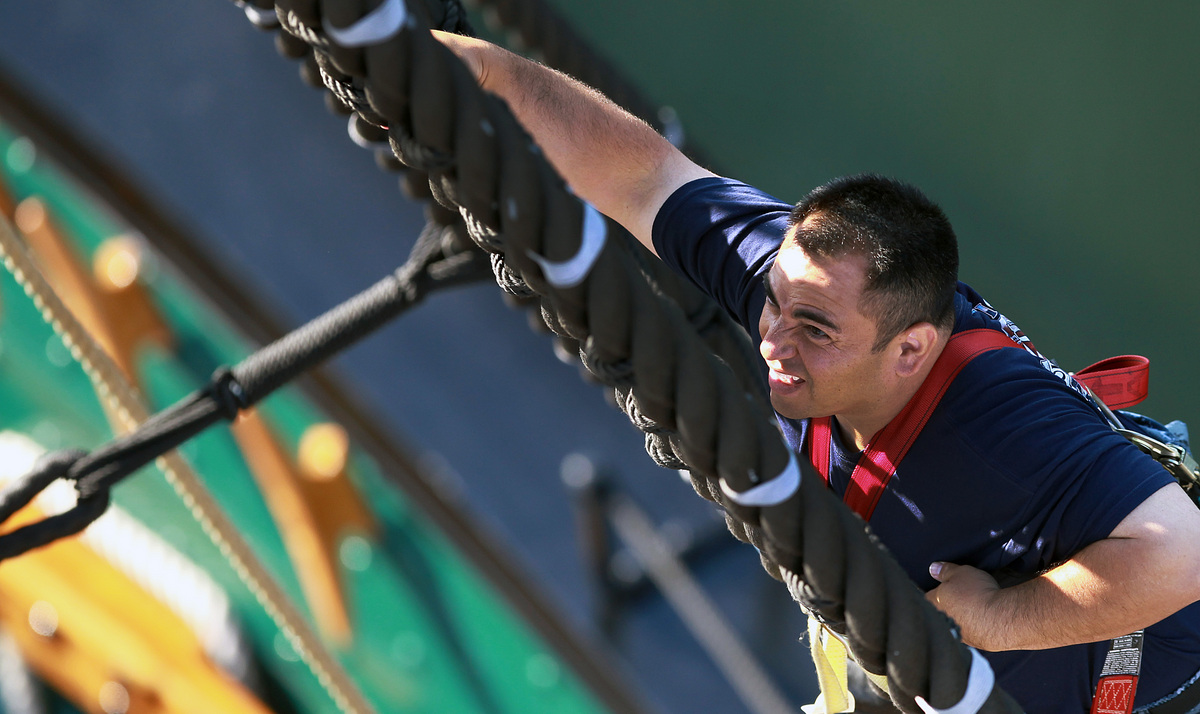 Cesar Villatoro, a chief select, climbs the rigging aboard the USS Constitution in Charlestown.