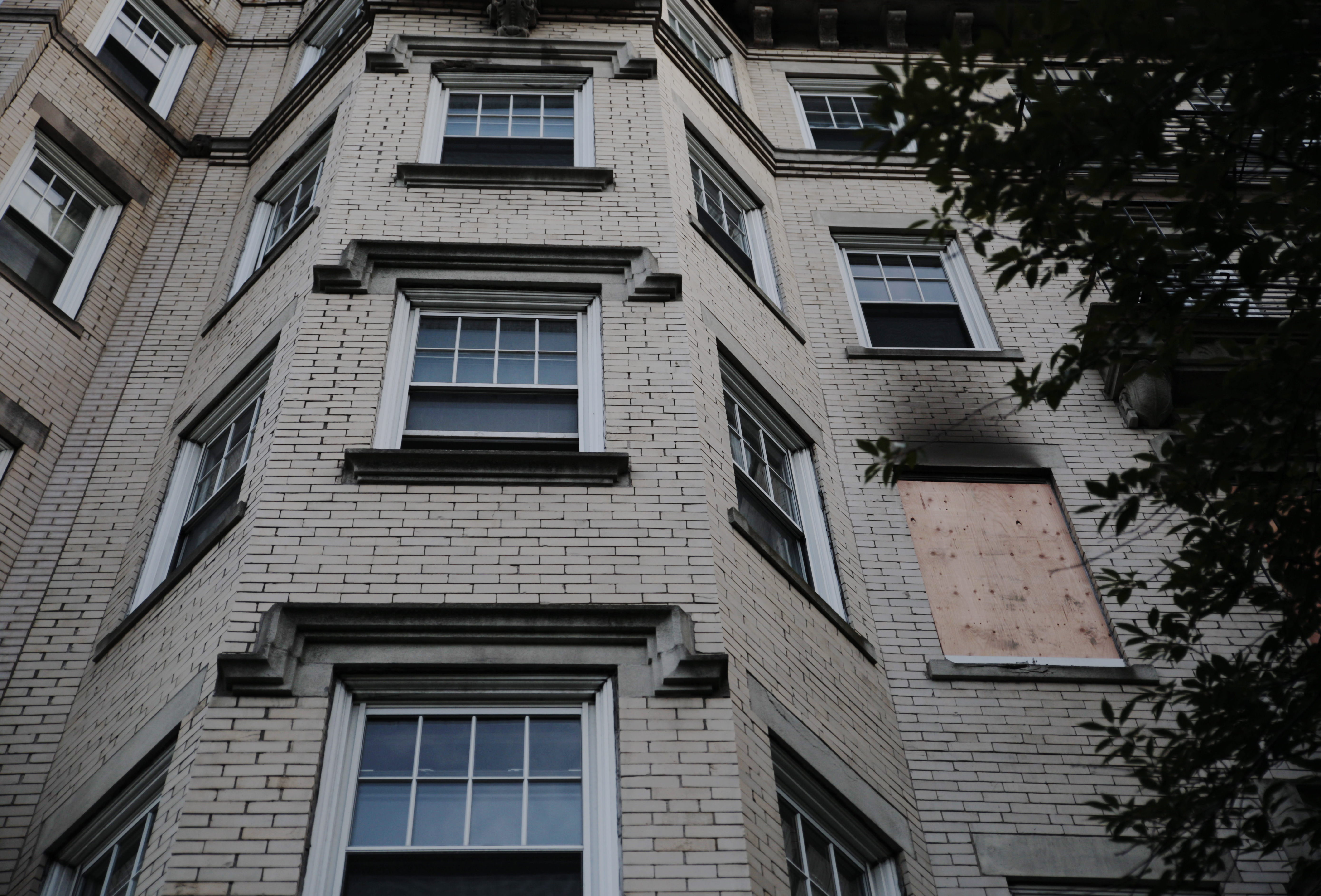 Boards were placed over the windows where a Boston University apartment on Commonwealth Avenue caught fire on Saturday.