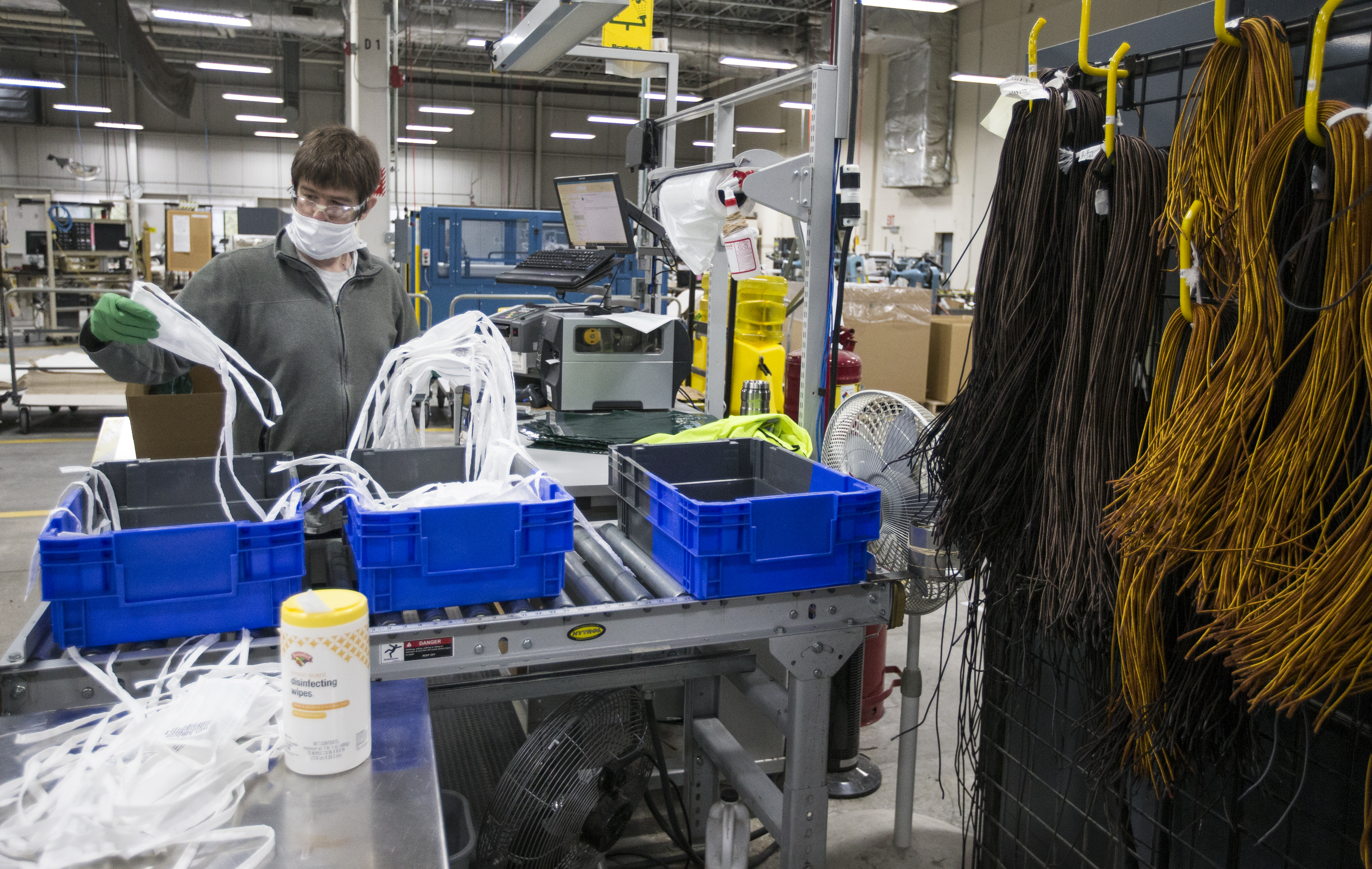 Nate Laine counted masks before packaging them next to reams of shoelaces at the L.L. Bean plant in Brunswick, Maine.