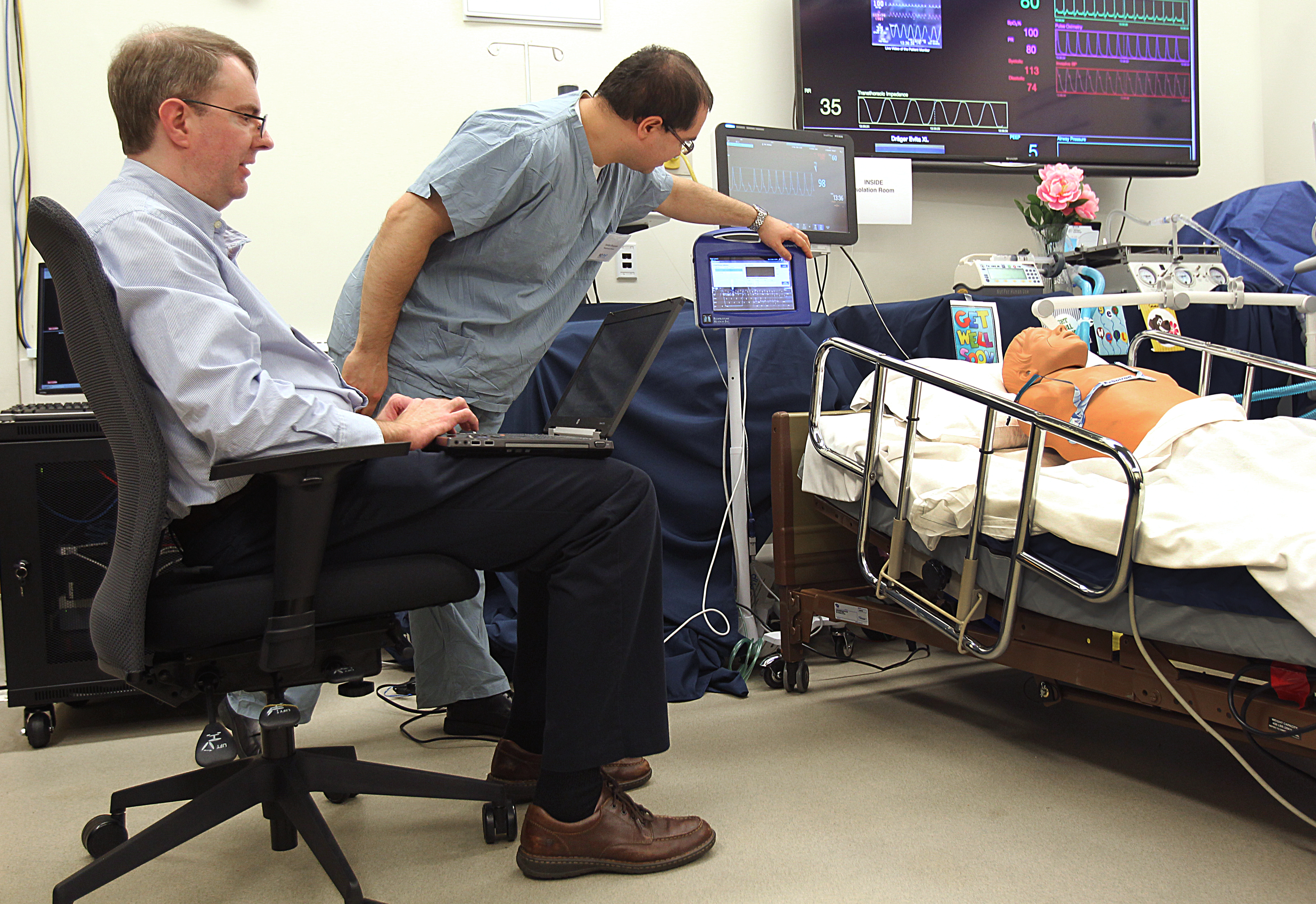 Jim Surine (right) and Jordan Brayanov demonstrated advances in treating Ebola patients.