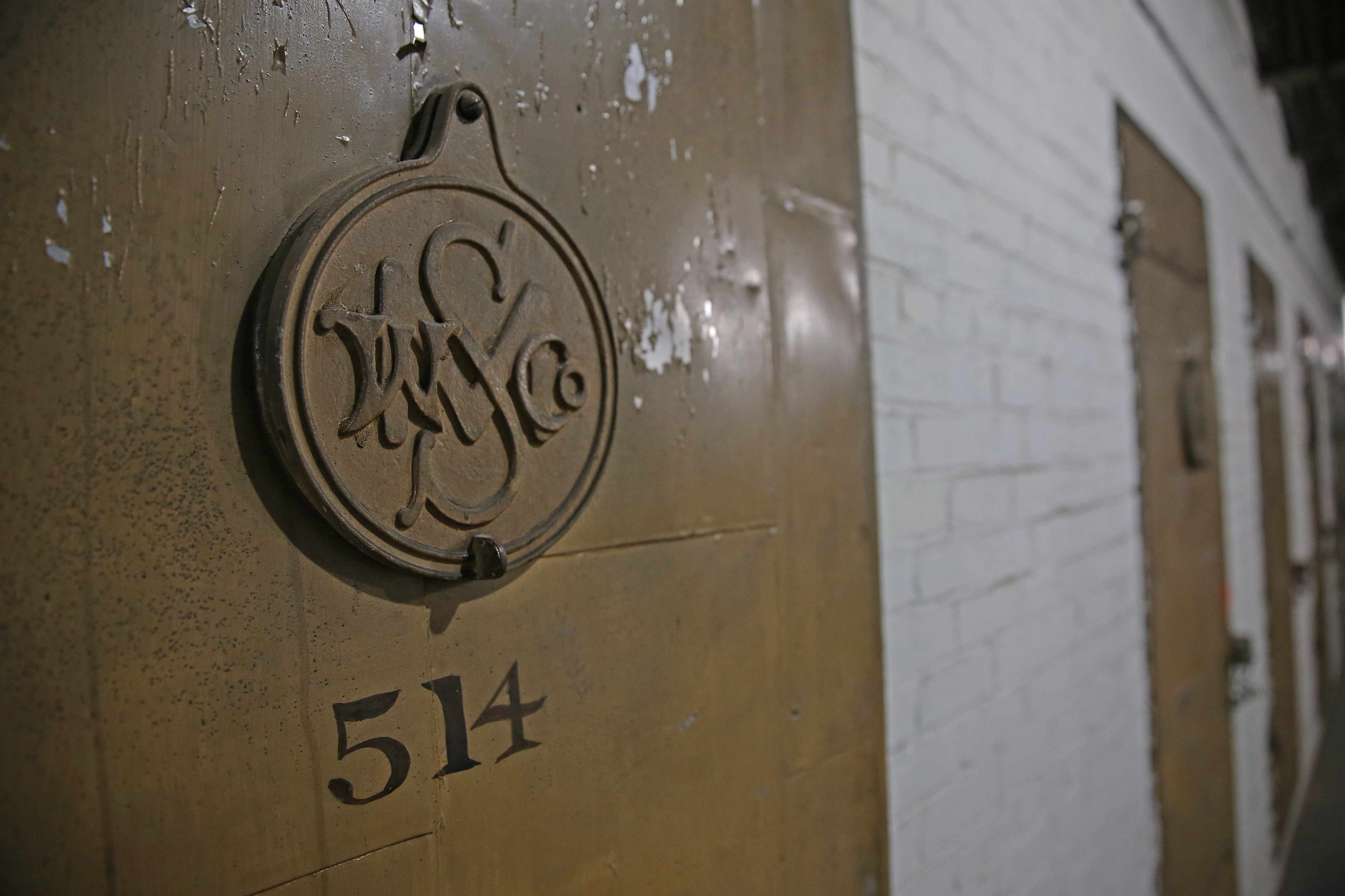 One of the doors to a storage bin, with a metal portal covering.