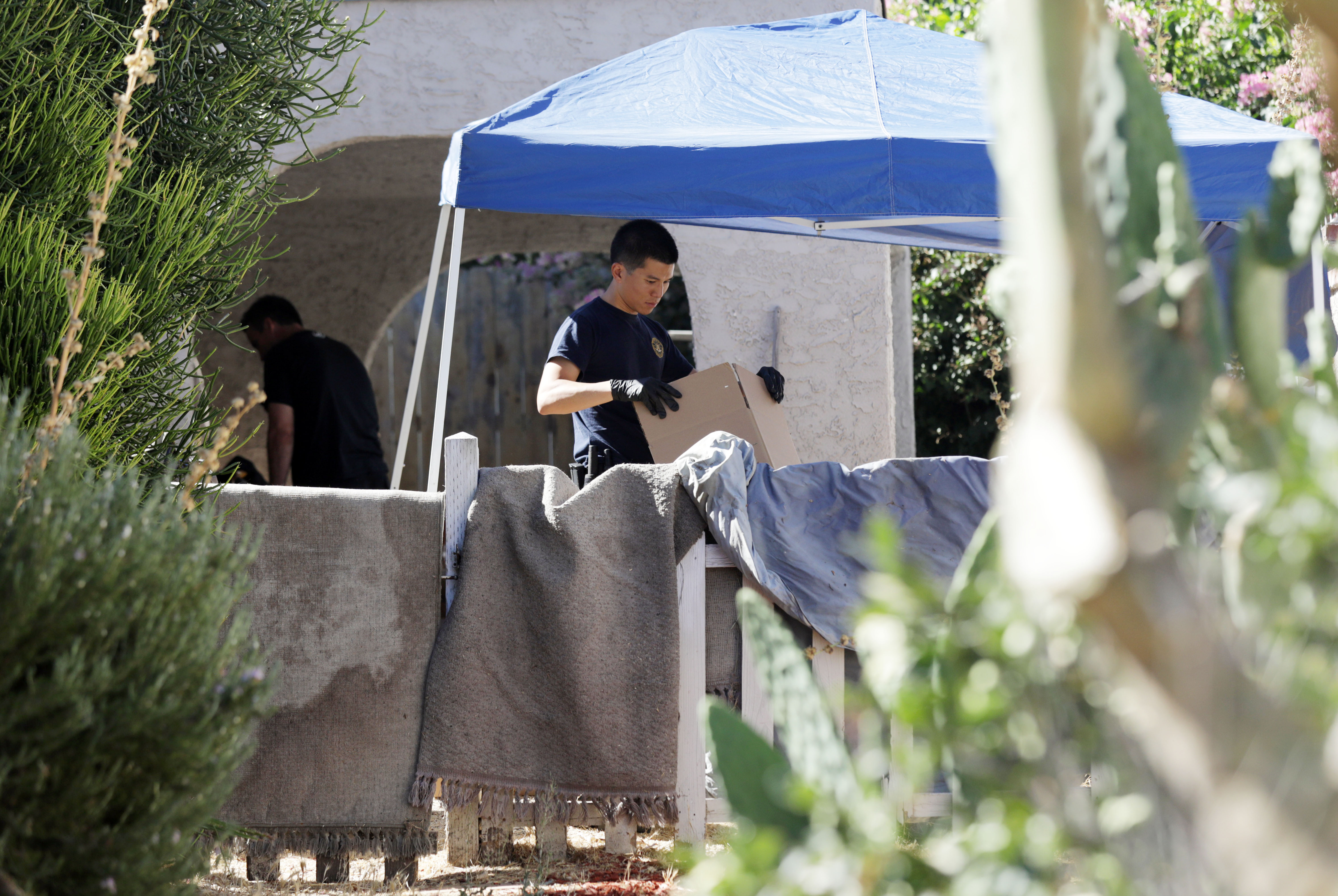 Investigators were seen in the Encino neighborhood of Los Angeles at the home of Robert Darrell Chain, who allegedly threatened to kill Boston Globe employees.