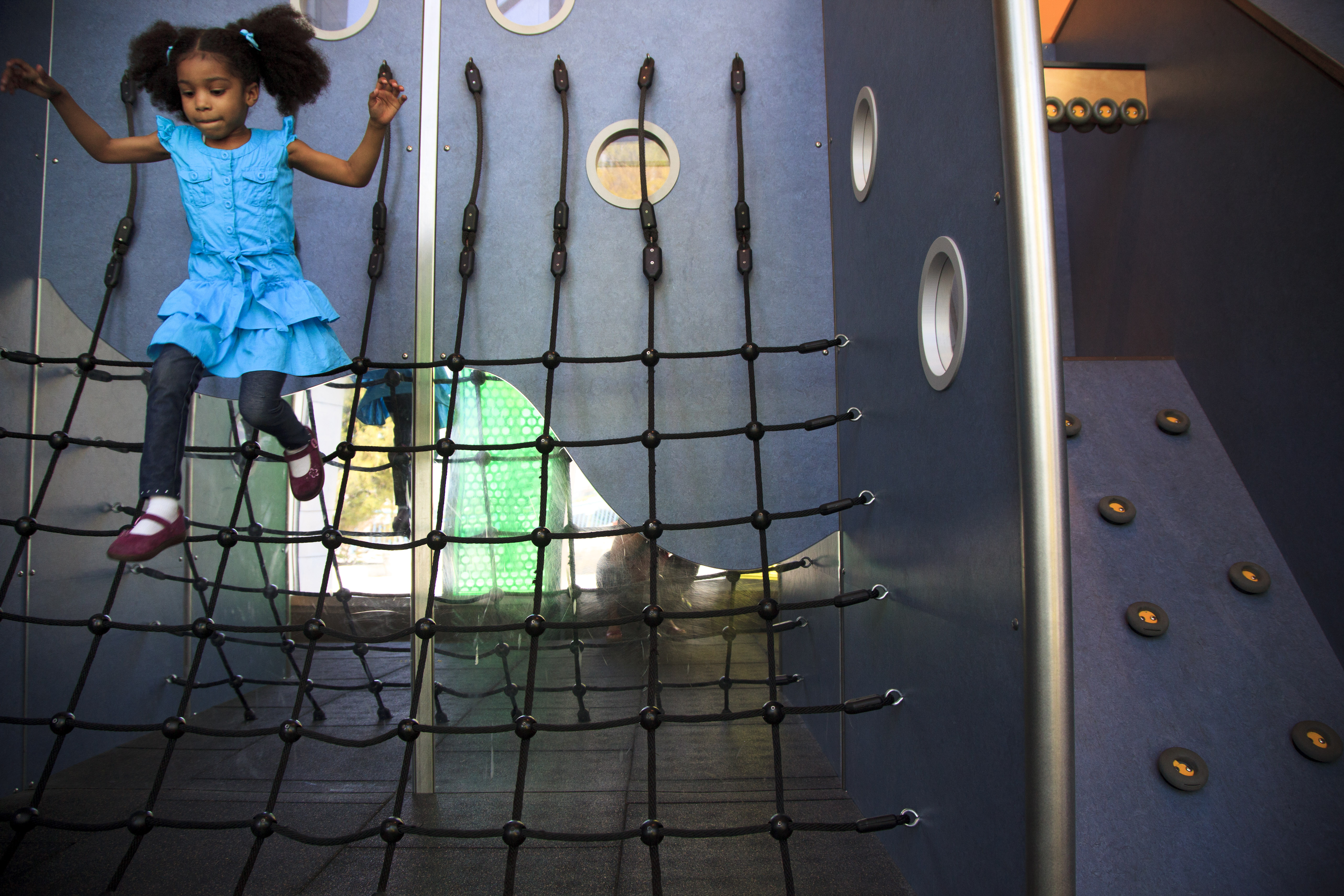 5/16/2013 - South Boston, MA - Maiya Stafford, cq, 5, of Dorchester, has fun with a jungle gym at the museum. For a story on the 100th anniversary of the Boston Children's Museum. Item: kidsatmuseum. Story by Katherine Tay Rushlau /Globe Staff. Dina Rudick/Globe Staff