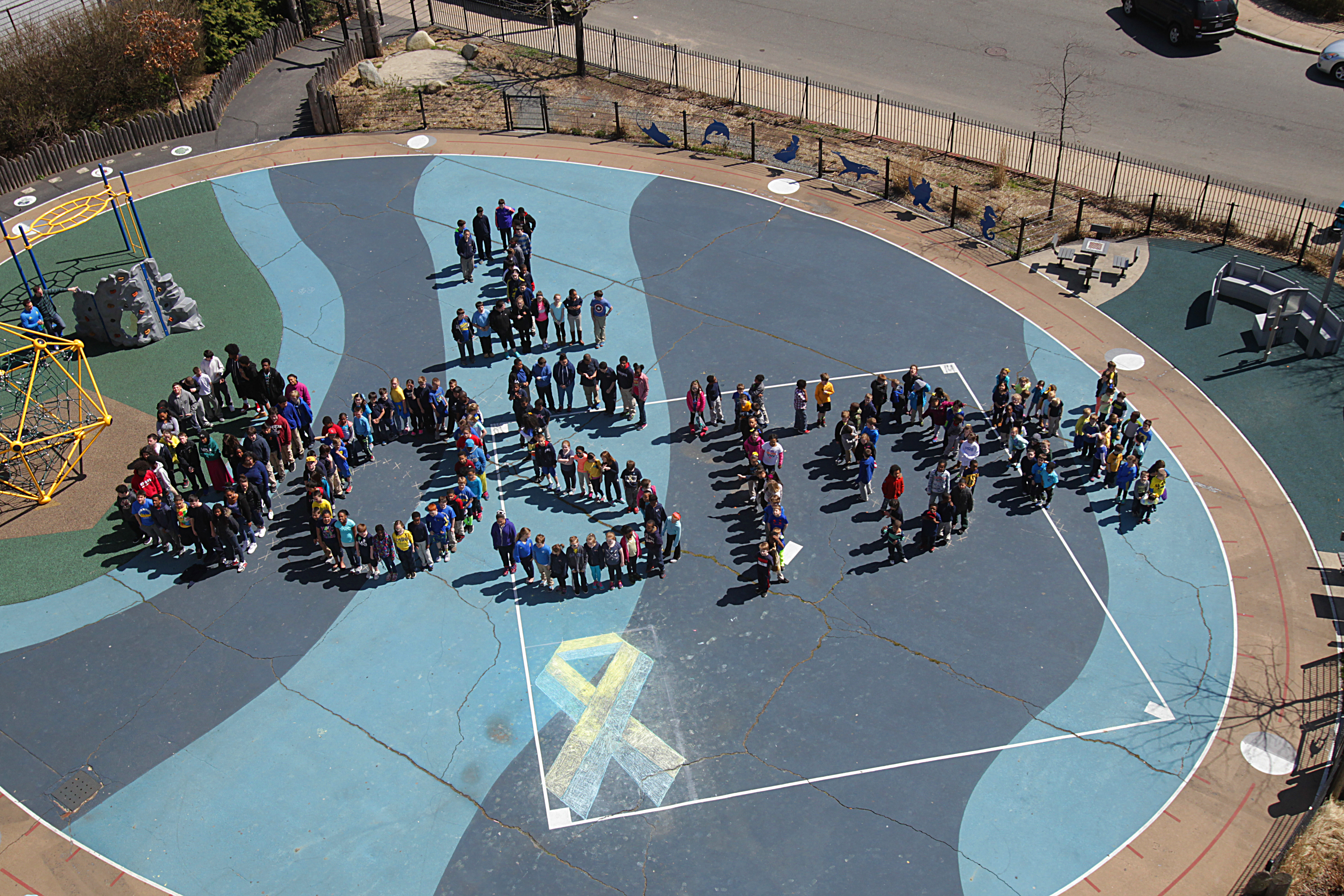 About 230 students at the Oliver Hazard Perry School spelled out One Boston on their playground.