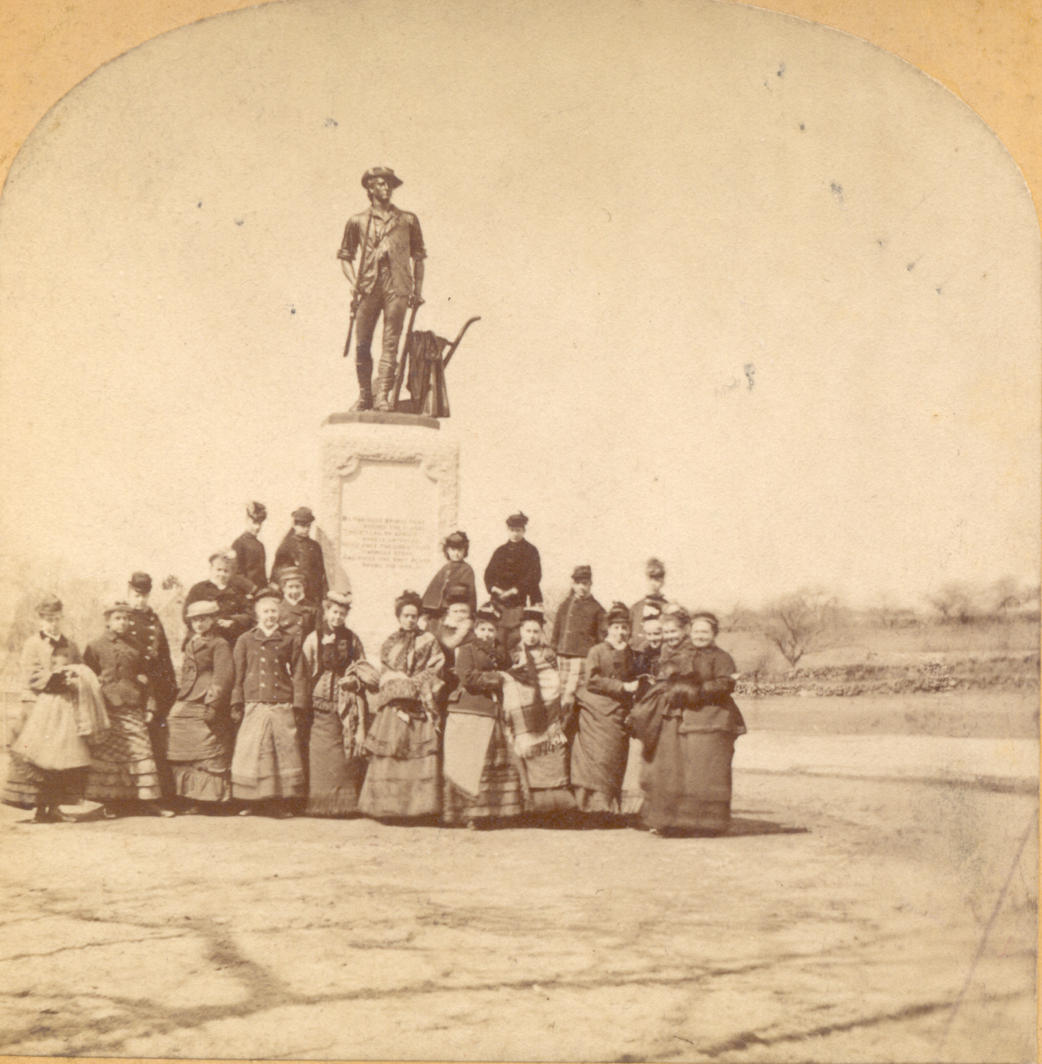 Women gathered in front of the Minute Man statue about the time of its unveiling in 1875.