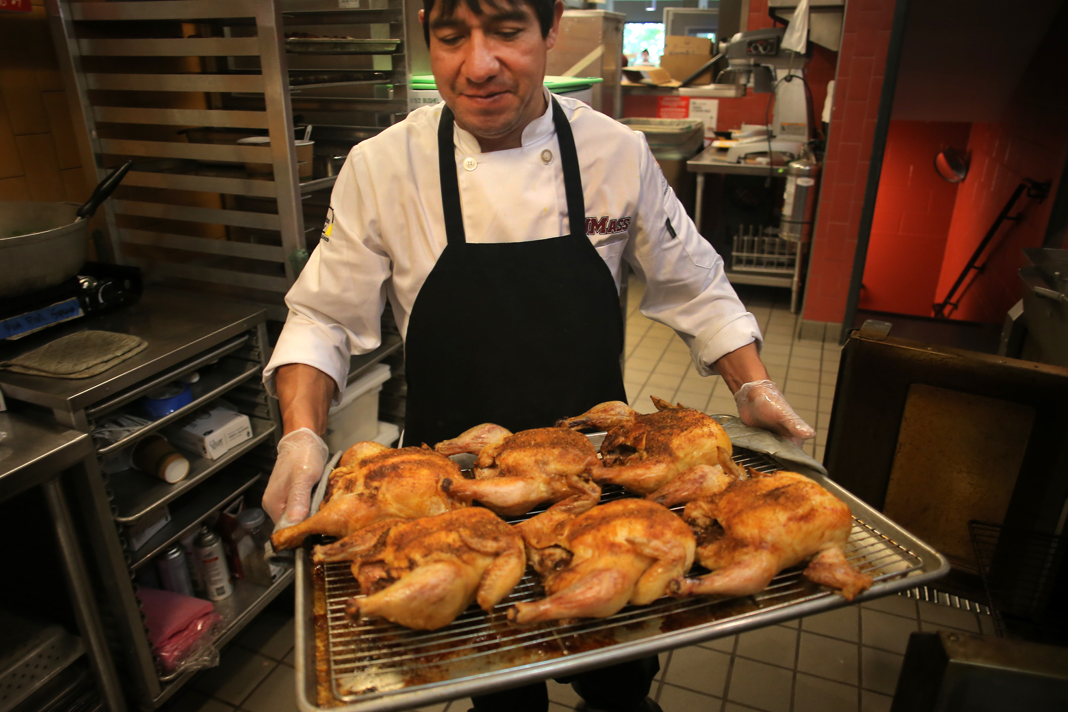 Manuel Morocho pulled roasted chickens from the oven.