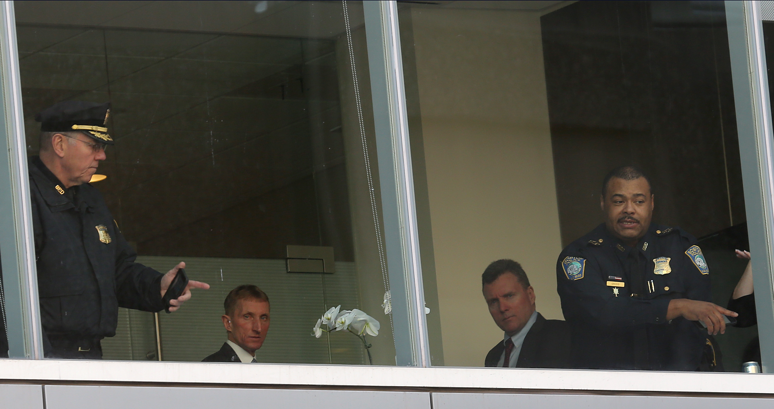 Boston Police Superintendent in Chief William Gross (right) and Commissioner William Evans (second from left) were on the second floor of the Brigham after the shooting.