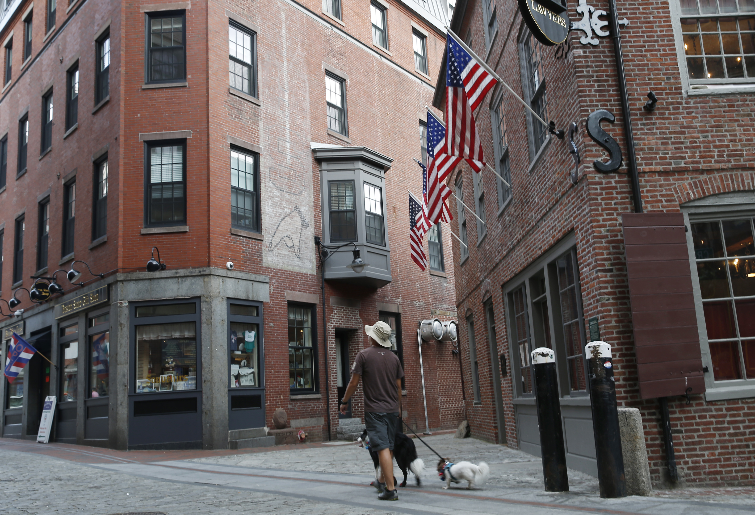 Aman walked dogs past a ghost sign of a hand pointing down on Marshall Street.