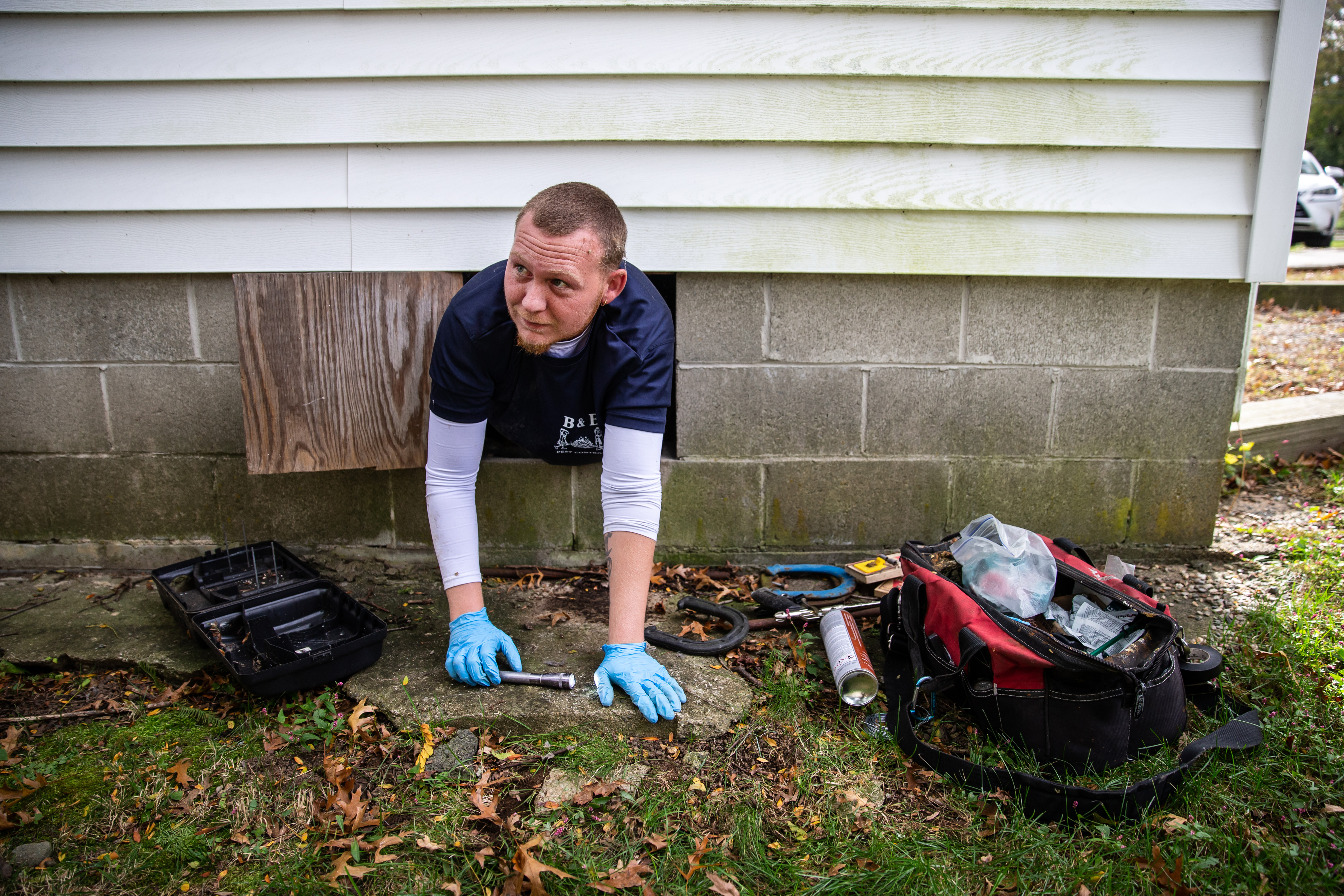 Rich Cyr entered a crawl space to place rat traps at a home in Marblehead.
