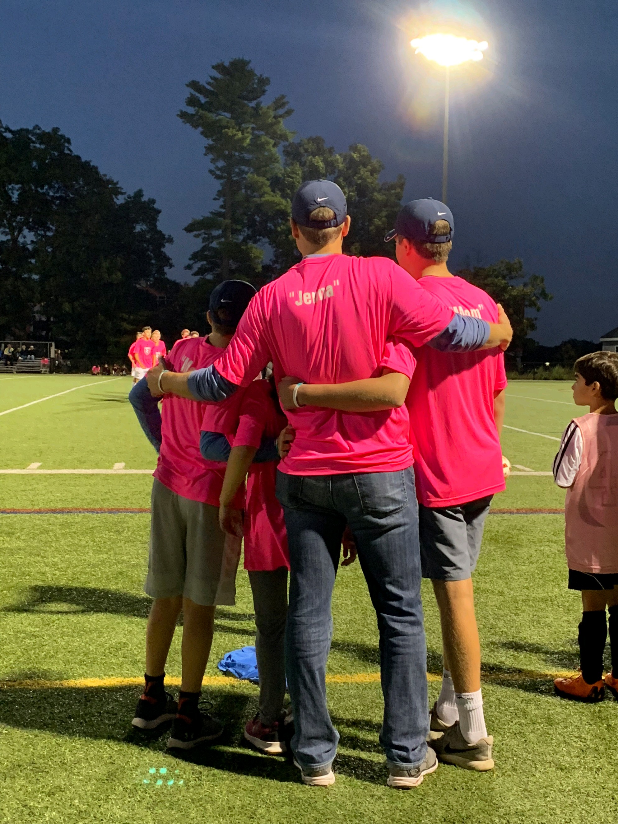 Derek Swaim (middle) and his children watched from the sideline as the Concord-Carlisle boys’ soccer team took on Lincoln-Sudbury Saturday night. The 12th Kicks for Cancer tournament honored his late wife, Jenna.