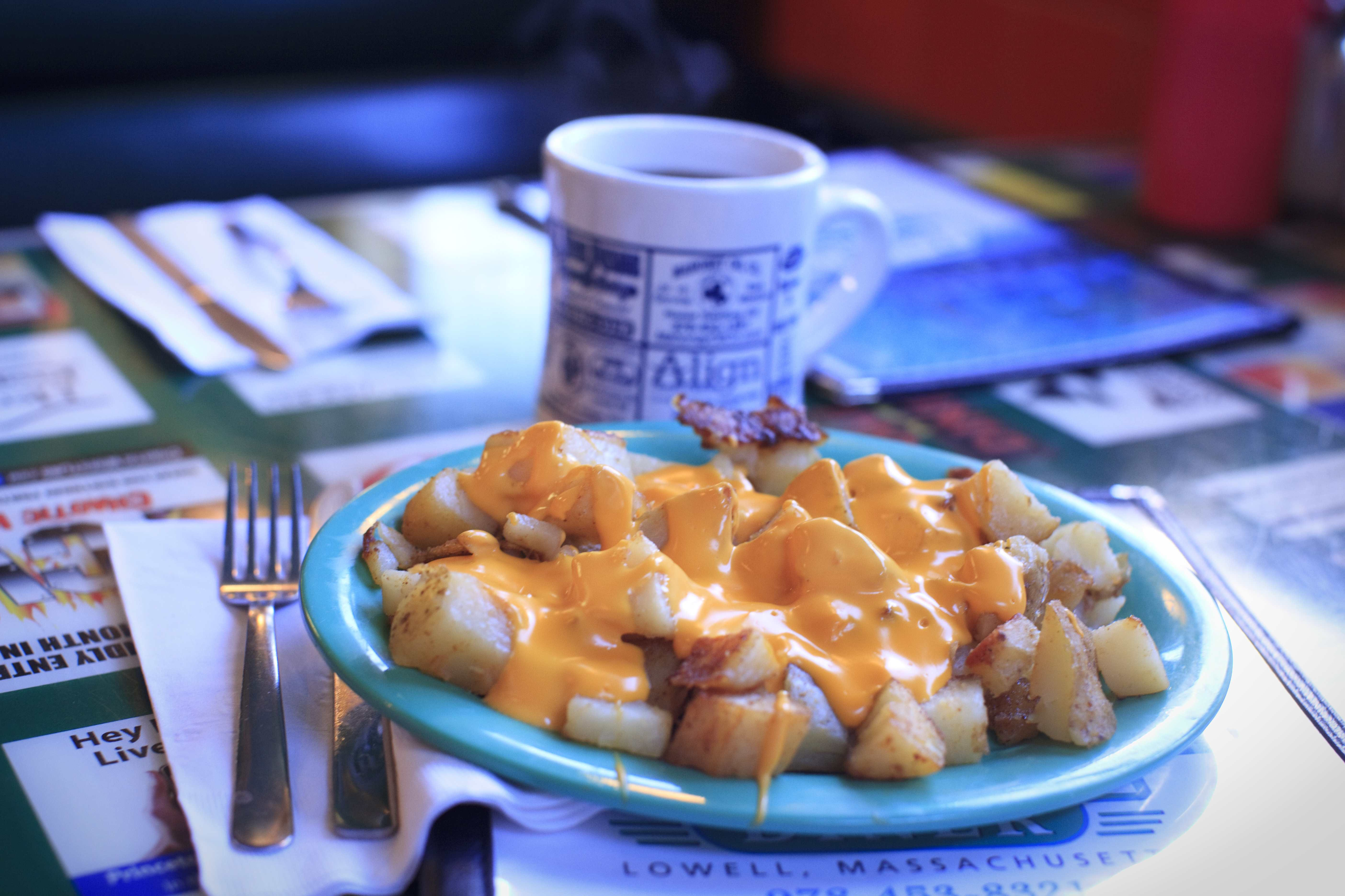 Home fries topped with bacon and cheddar cheese at Four Sisters Owl.