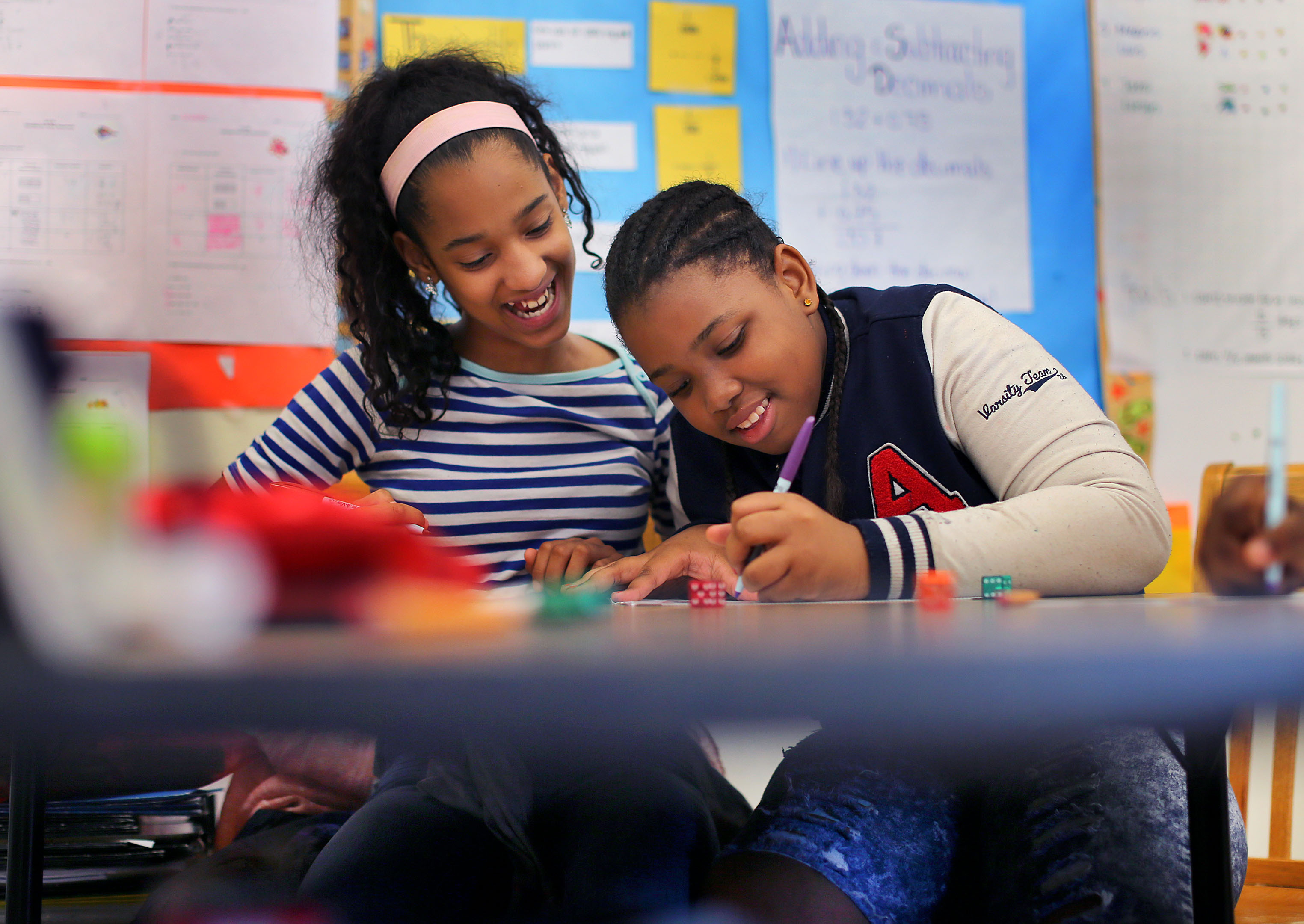 Sonia Luzon (left), 12, and Shawniya Smith, 11, worked on a math problem at the Dever Elementary School.
