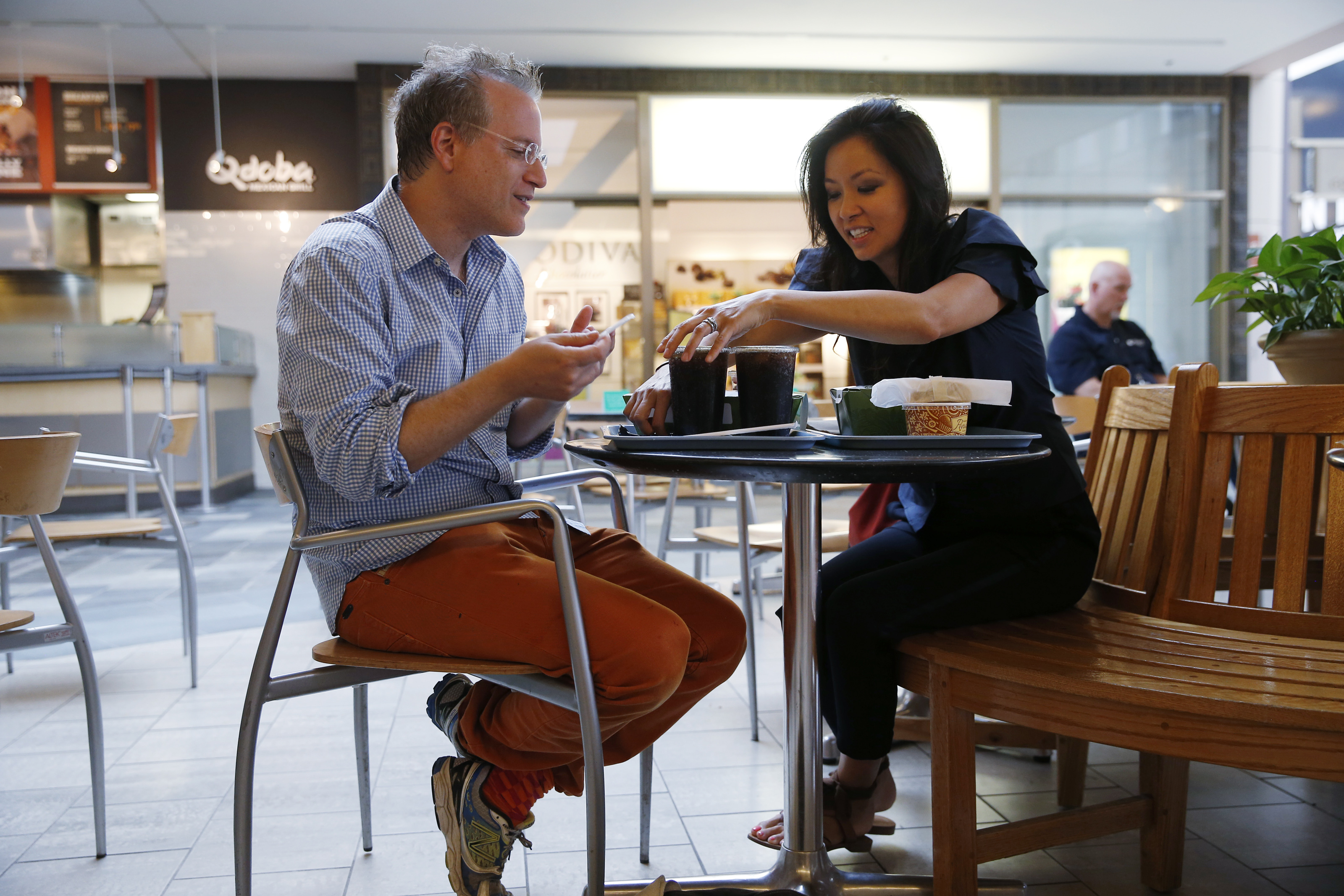 10:37 a.m. Mezrich and his wife, Tonya, share a meal at the food court at the Shops at the Prudential Center.