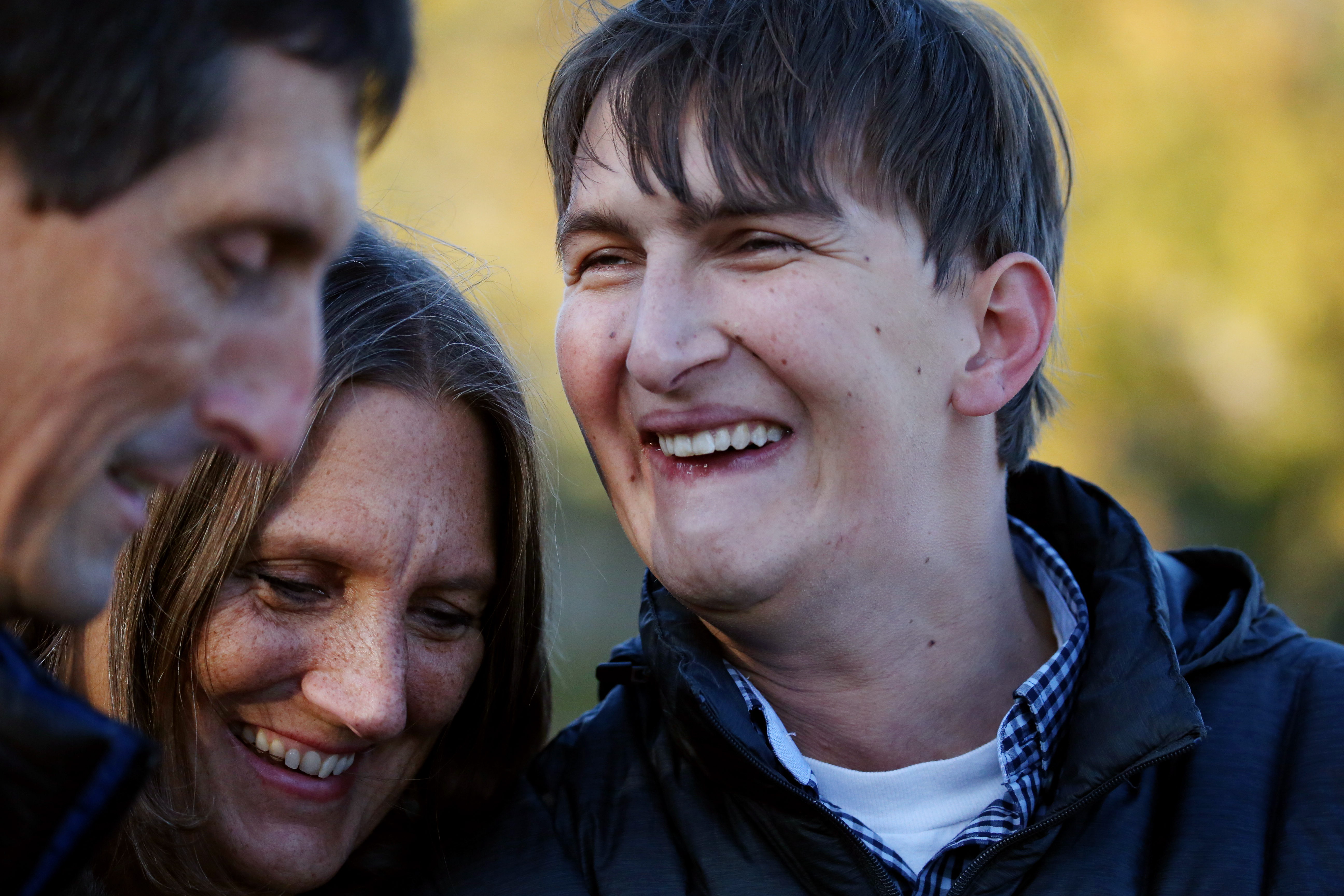 Former Buckingham, Browne & Nichols School football player Zach McLeod, 27, shares a moment with his parents, Pat and Tammy.