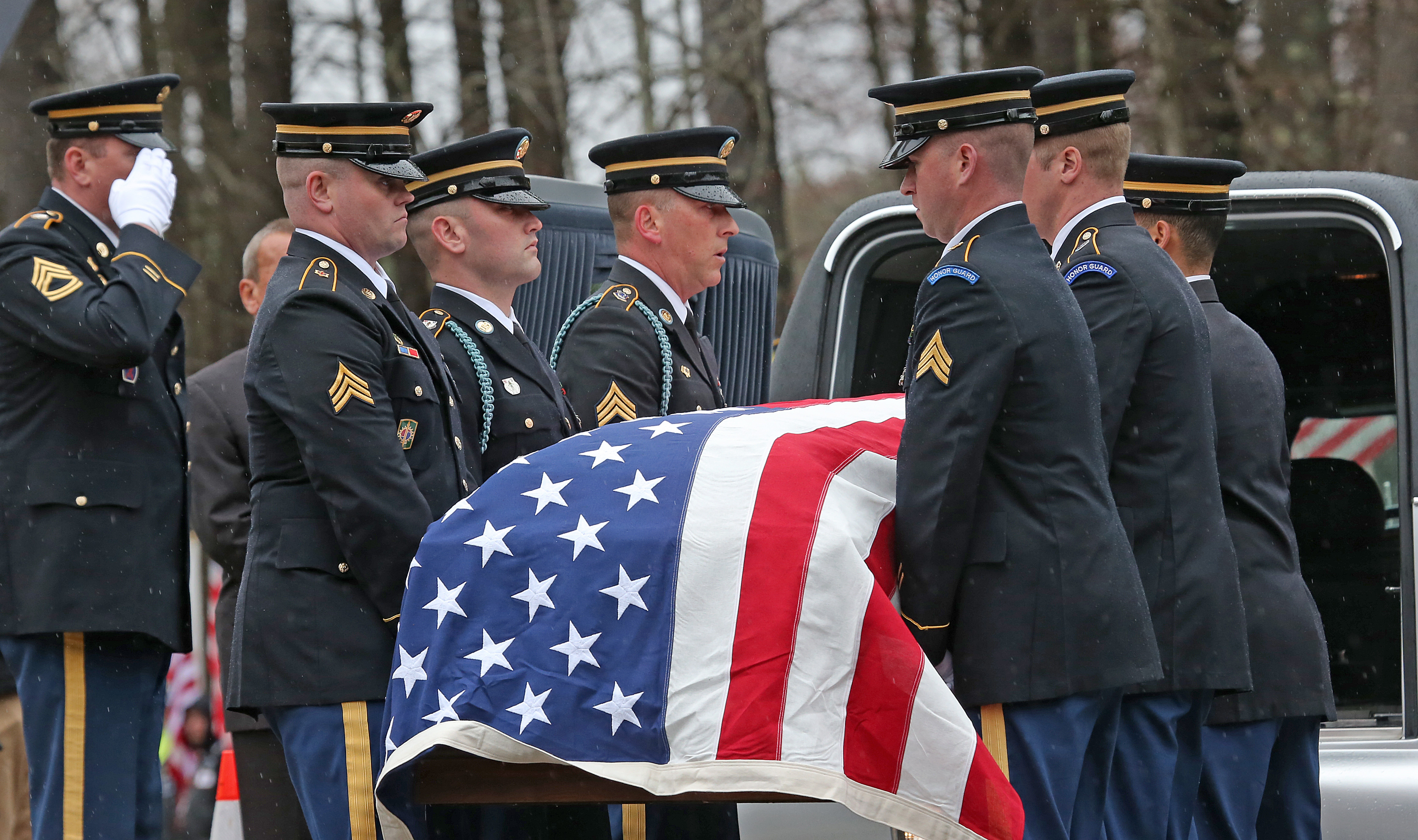 The Honor Guard brought the flag-draped casket to the church.