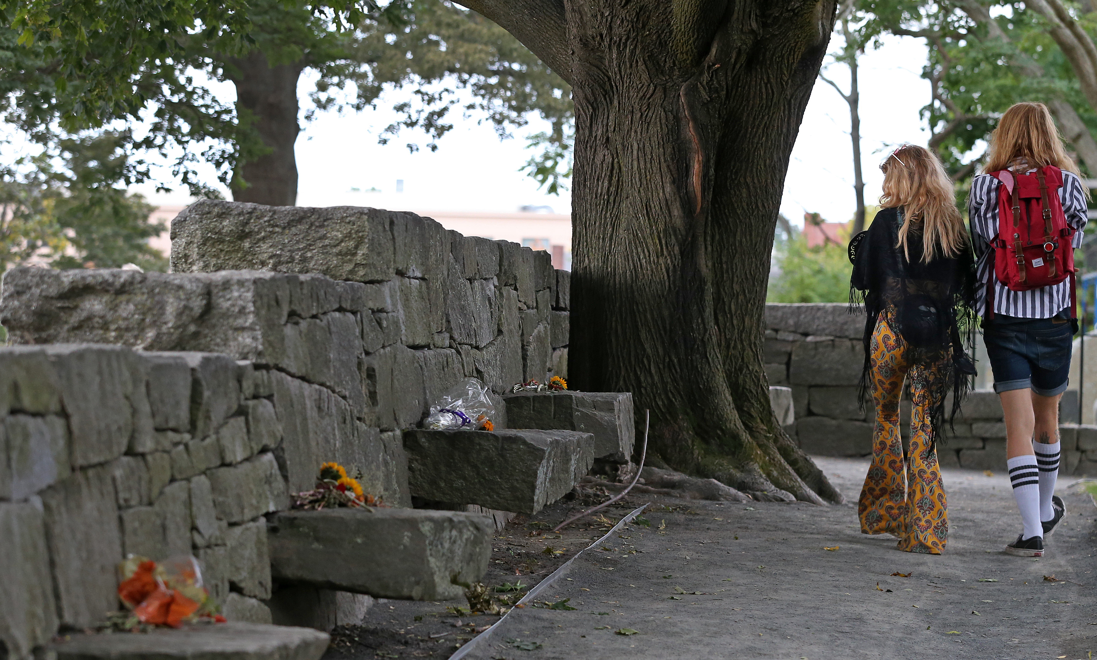 Visitors walk by the Salem Witch Memorial.