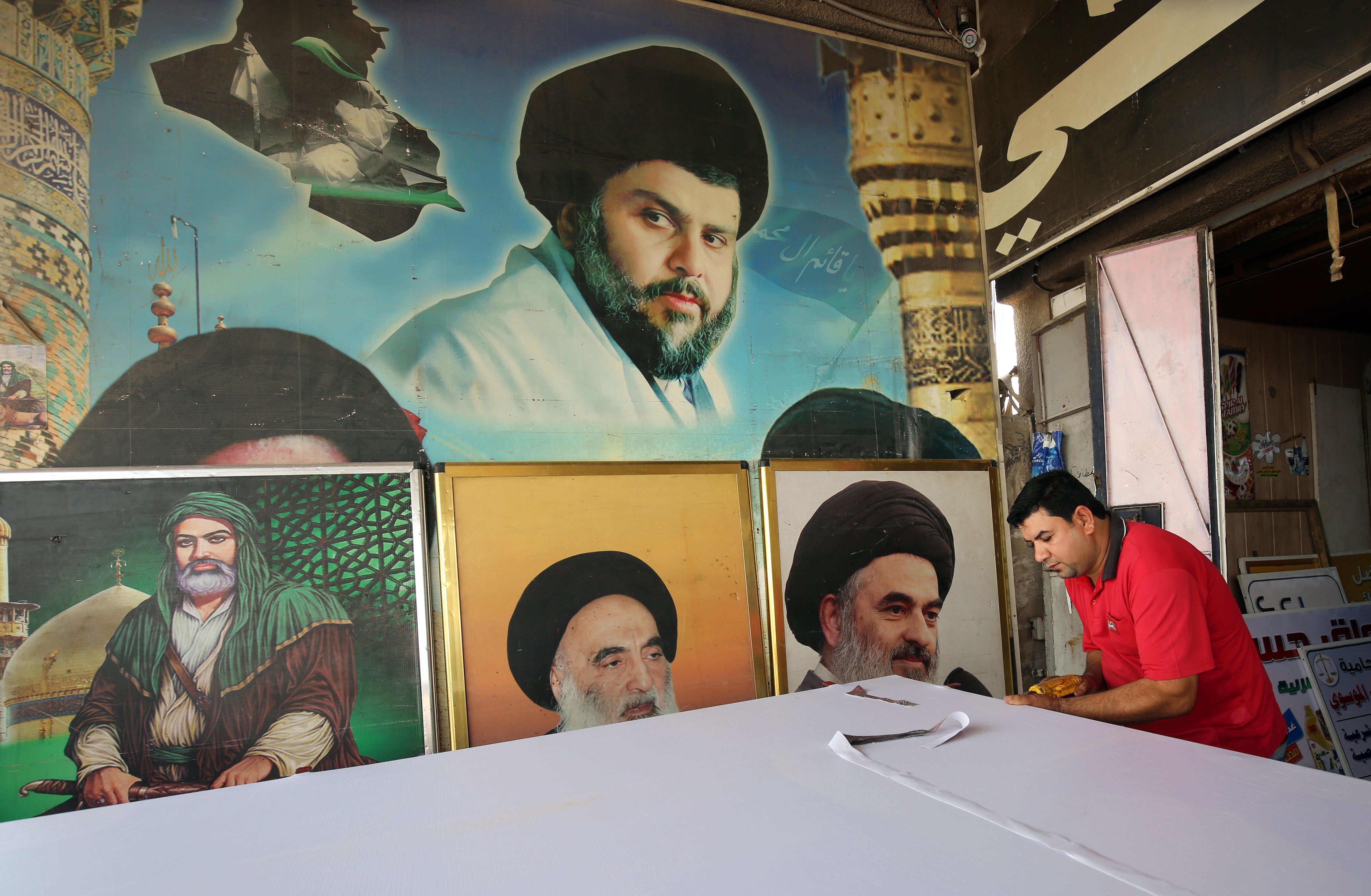 An Iraqi man works on a poster of Shiite cleric Moqtada al-Sadr at a printing shop in Sadr City, a suburb of Baghdad.