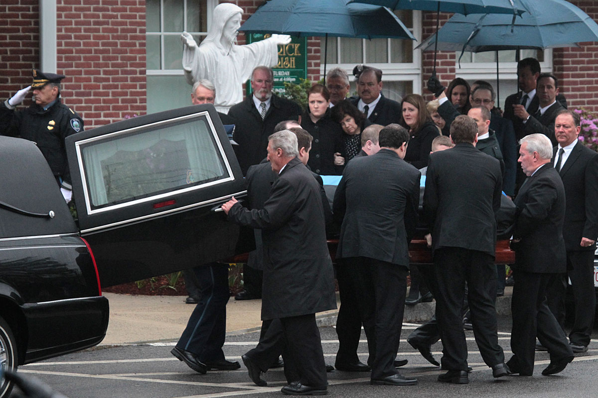 Members of Sean Collier’s family waited to enter St. Patrick’s Church in Stoneham Tuesday.
