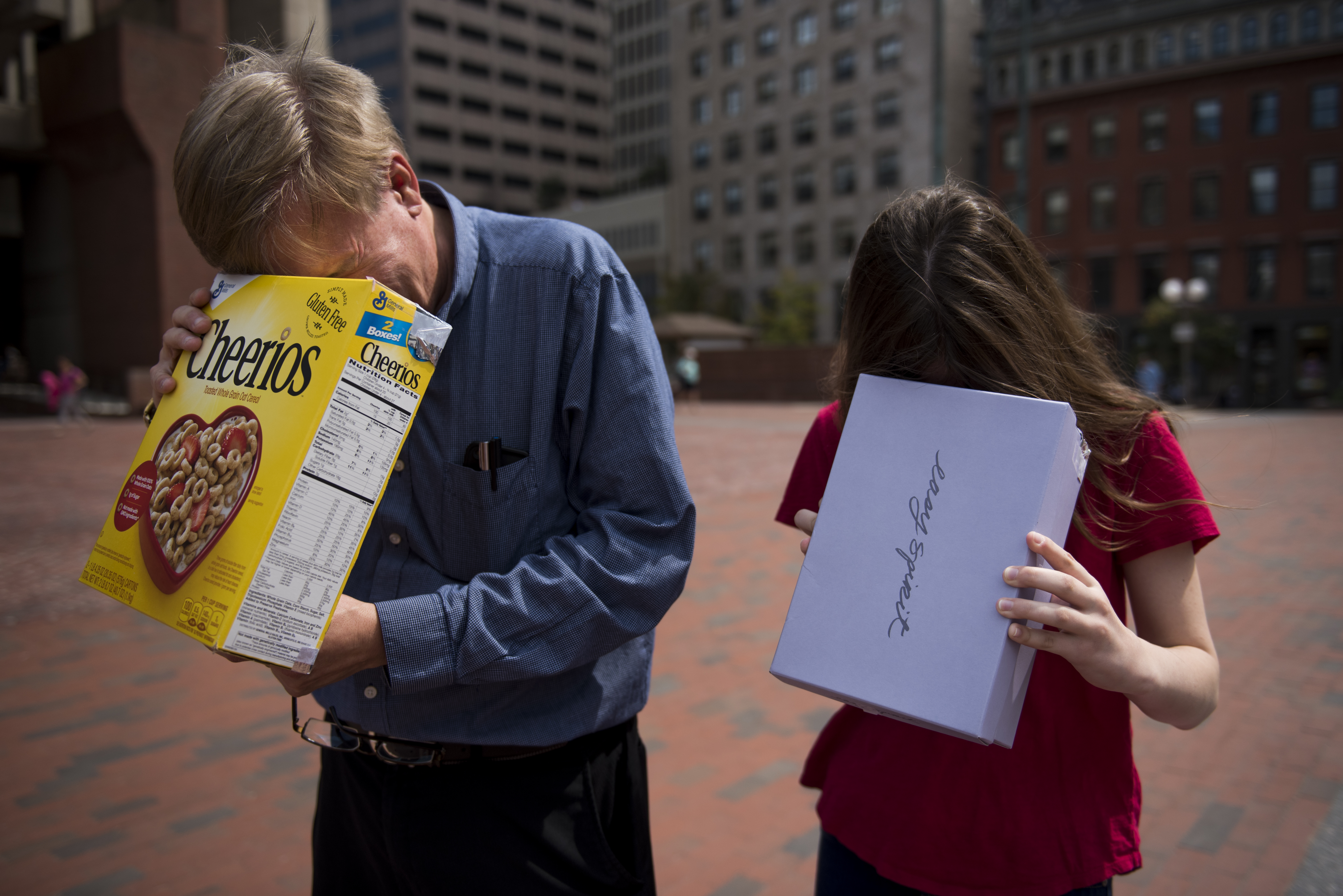 Mike Wilson, left, and his daughter Stephanie, check out the partial solar eclipse in City Hall Plaza.