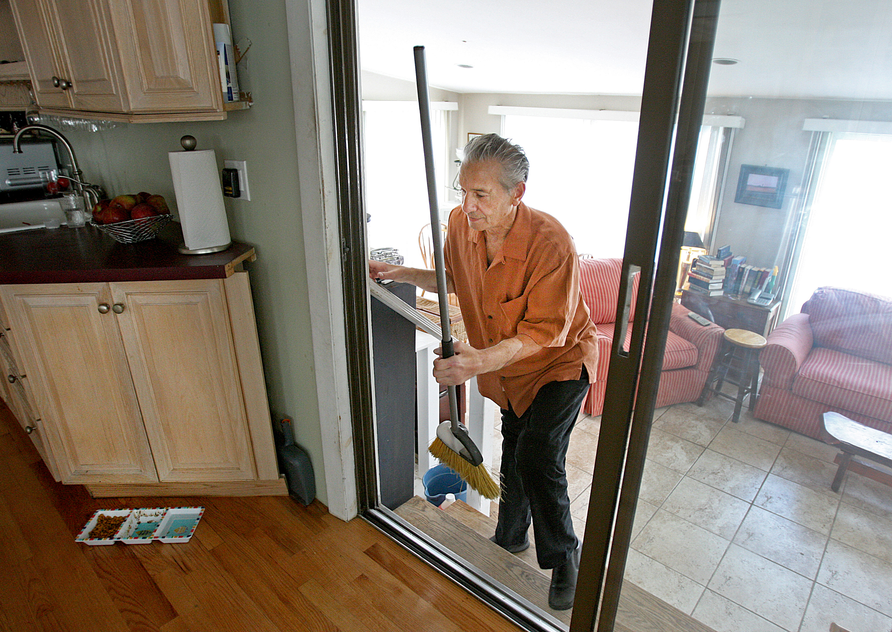 Following his transplant, Richard Mangino is able to do chores around his home.