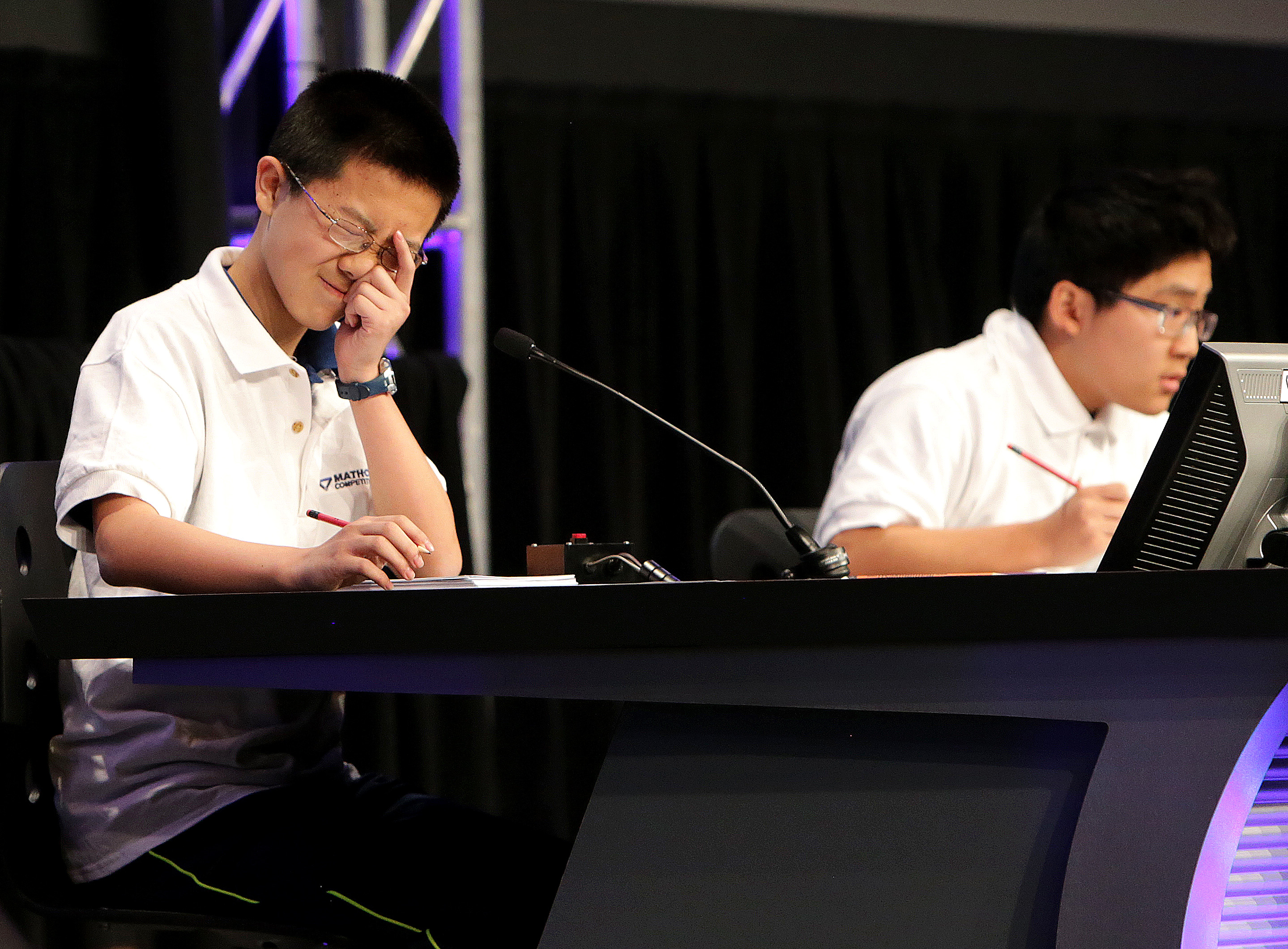 Kevin Liu of Carmel, Ind., pondered a question as he faced Frank Han (right) of Minnesota.