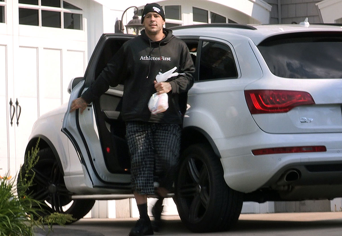 Aaron Hernandez arrived at his house in North Attleborough, as reporters camped outside expected action by investigators.