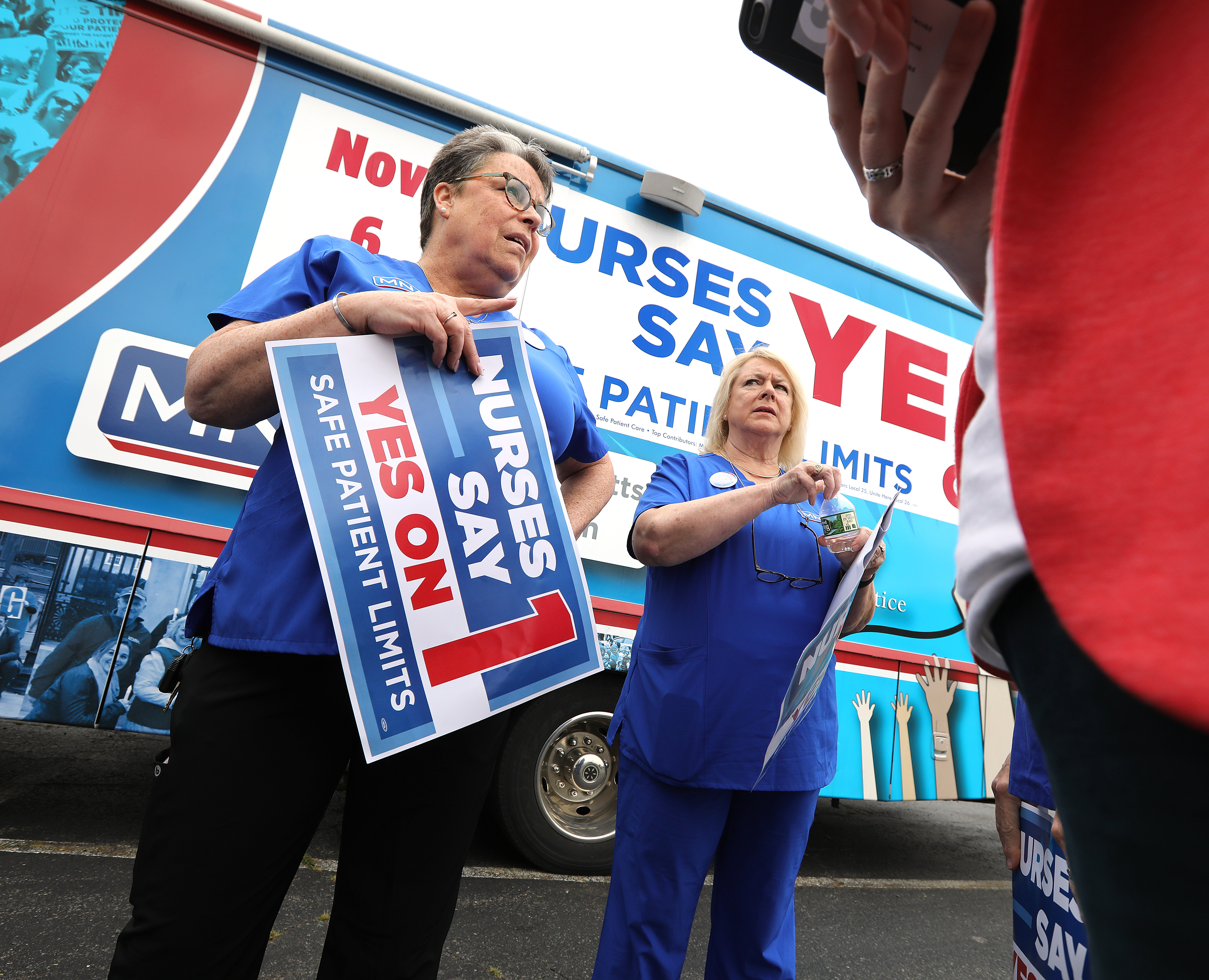 Karen Coughlin (left) and Donna Kelly-Williams, president of the Massachusetts Nurses Association, during Tuesday’s news conference at the Somerville headquarters of Partners HealthCare.