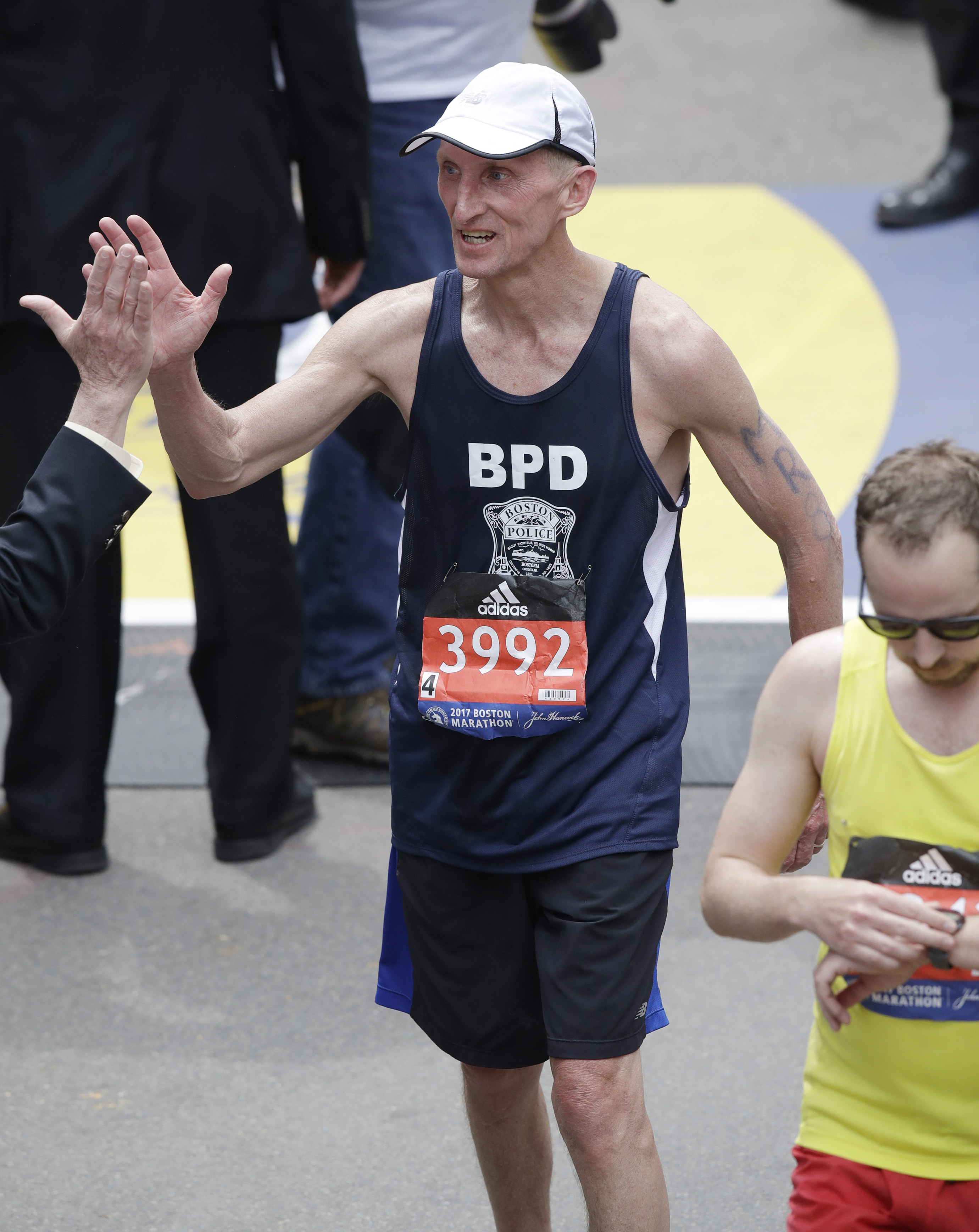 Boston Police Commissioner William Evans was congratulated after finishing the 121st Boston Marathon.