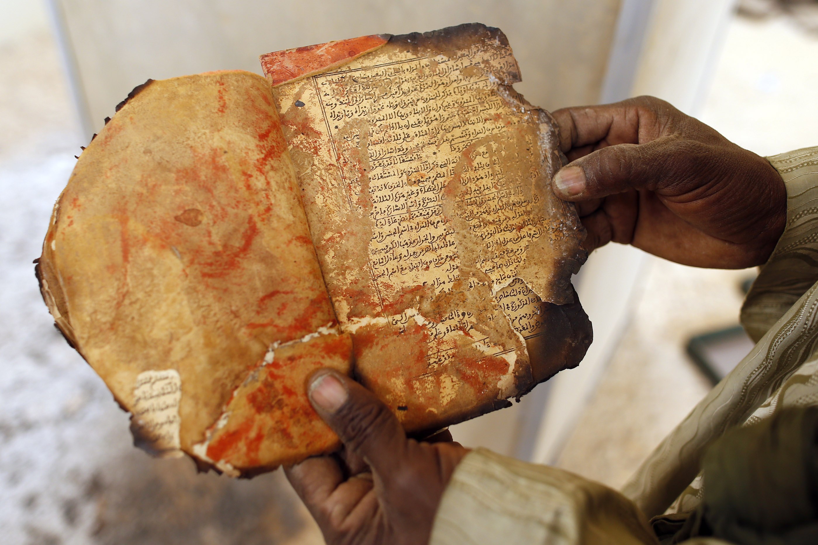 A museum guard displayed a burnt ancient manuscript at the Ahmed Baba Institute last month.