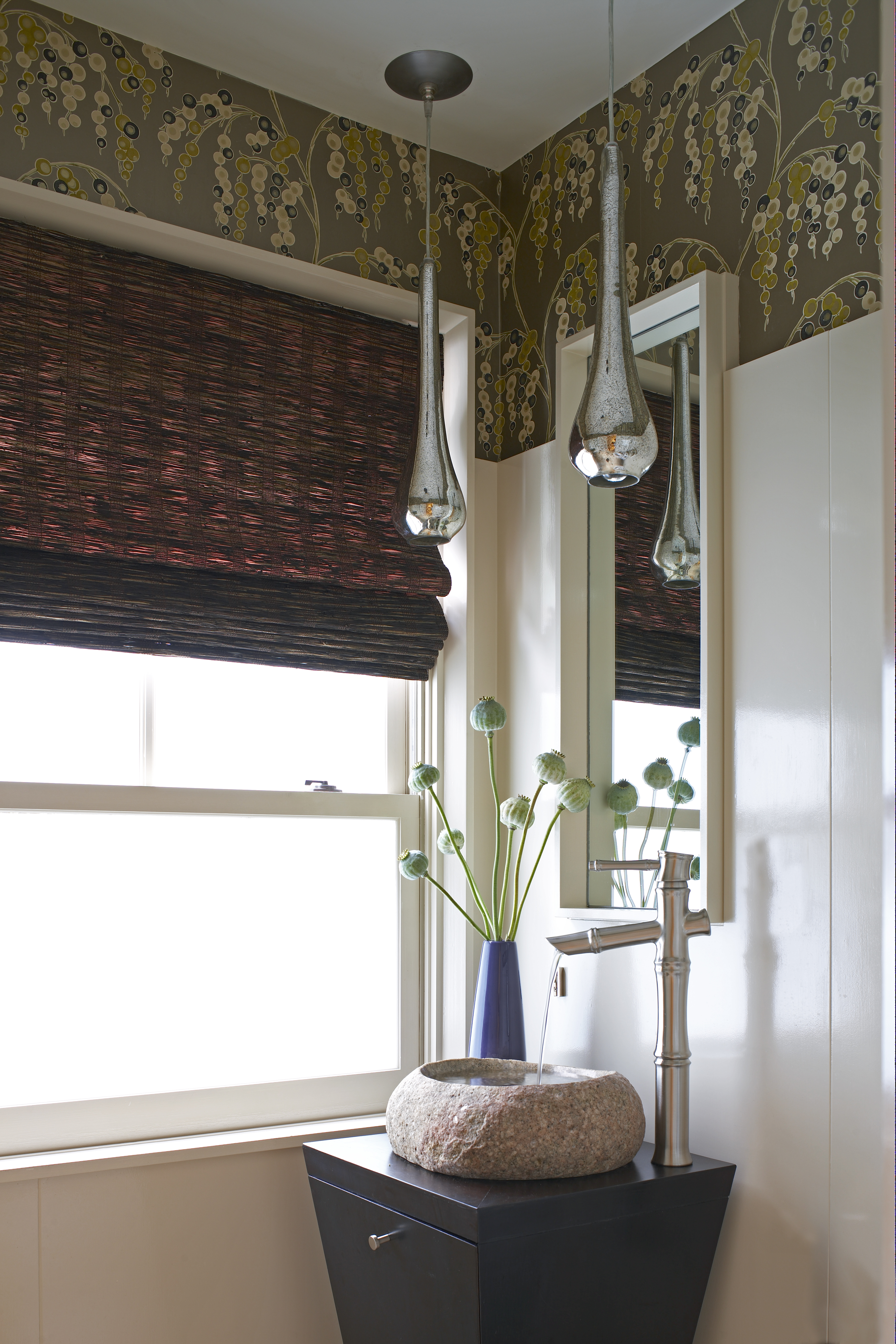 To draw attention to the upper two-thirds of a room, use wallcoverings or drapery, then top it all of with a showstopping piece of suspended lighting.