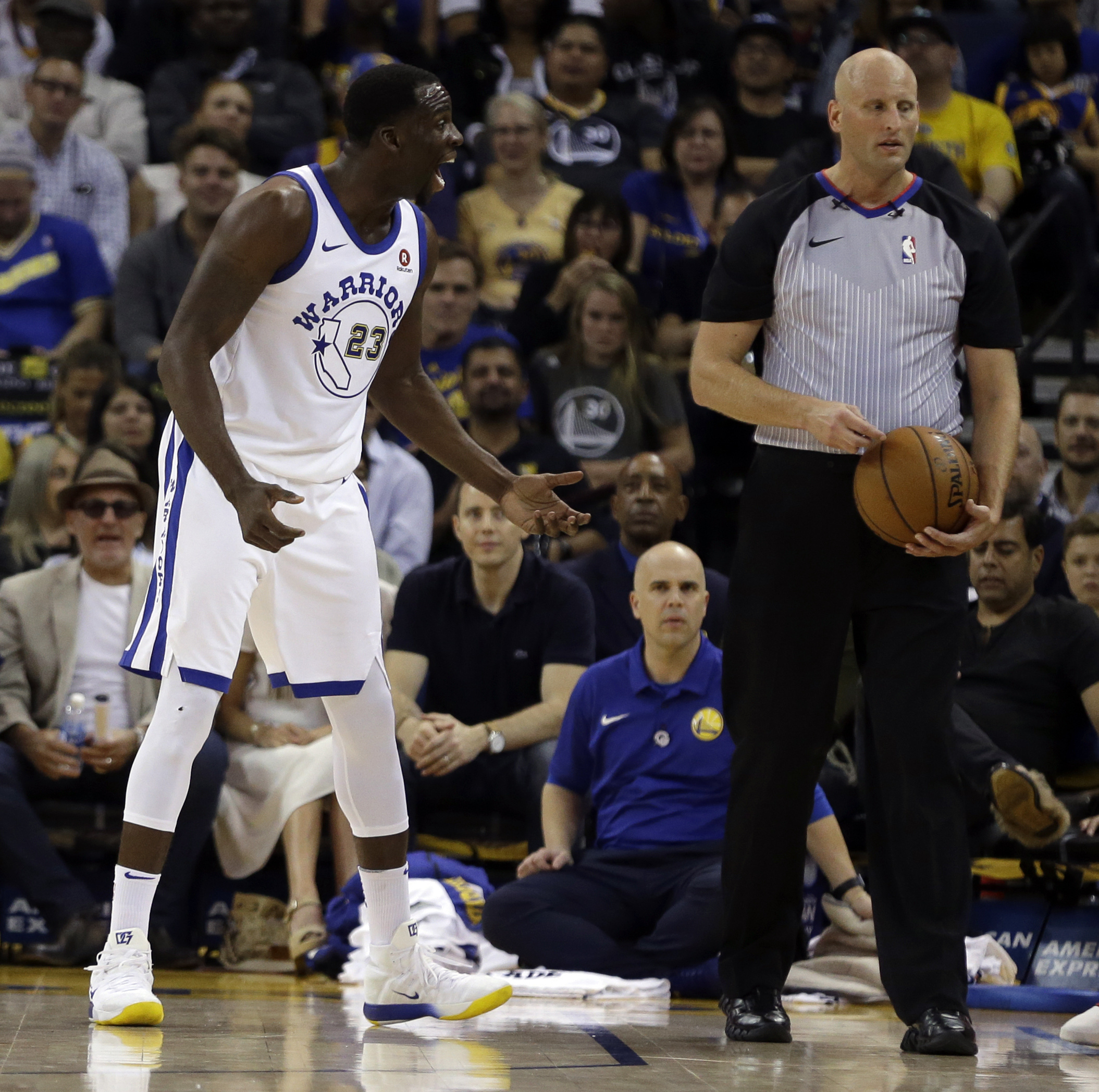 Golden State’s Draymond Green (left) argues with a referee during the first half. Green would pick up one technical, then get tossed for fighting before halftime.