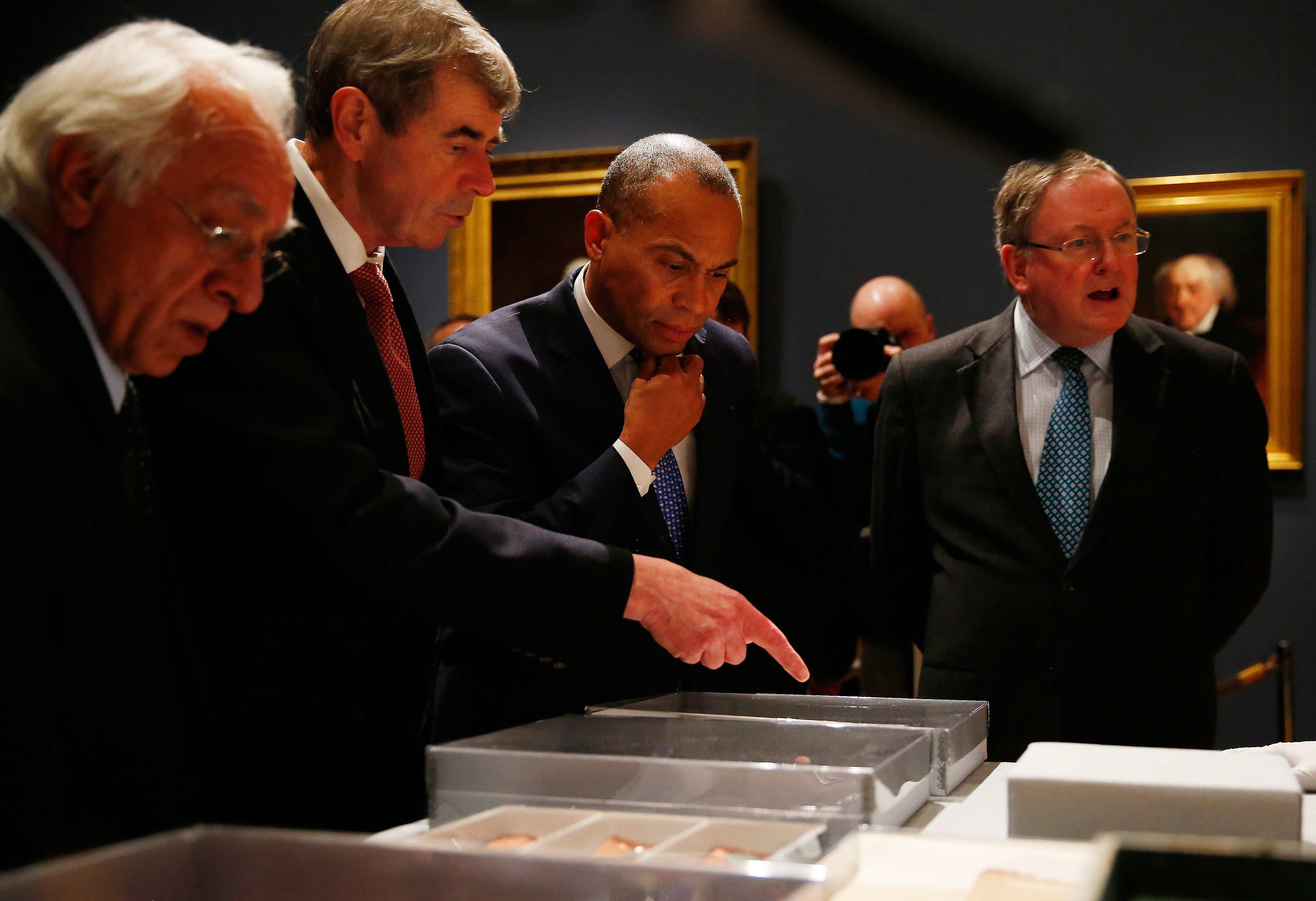 Secretary of State William Galvin, who is also chairman of the Massachusetts Historical Commission, second from left, pointed to an object as Governor Deval Patrick, center, looked on.