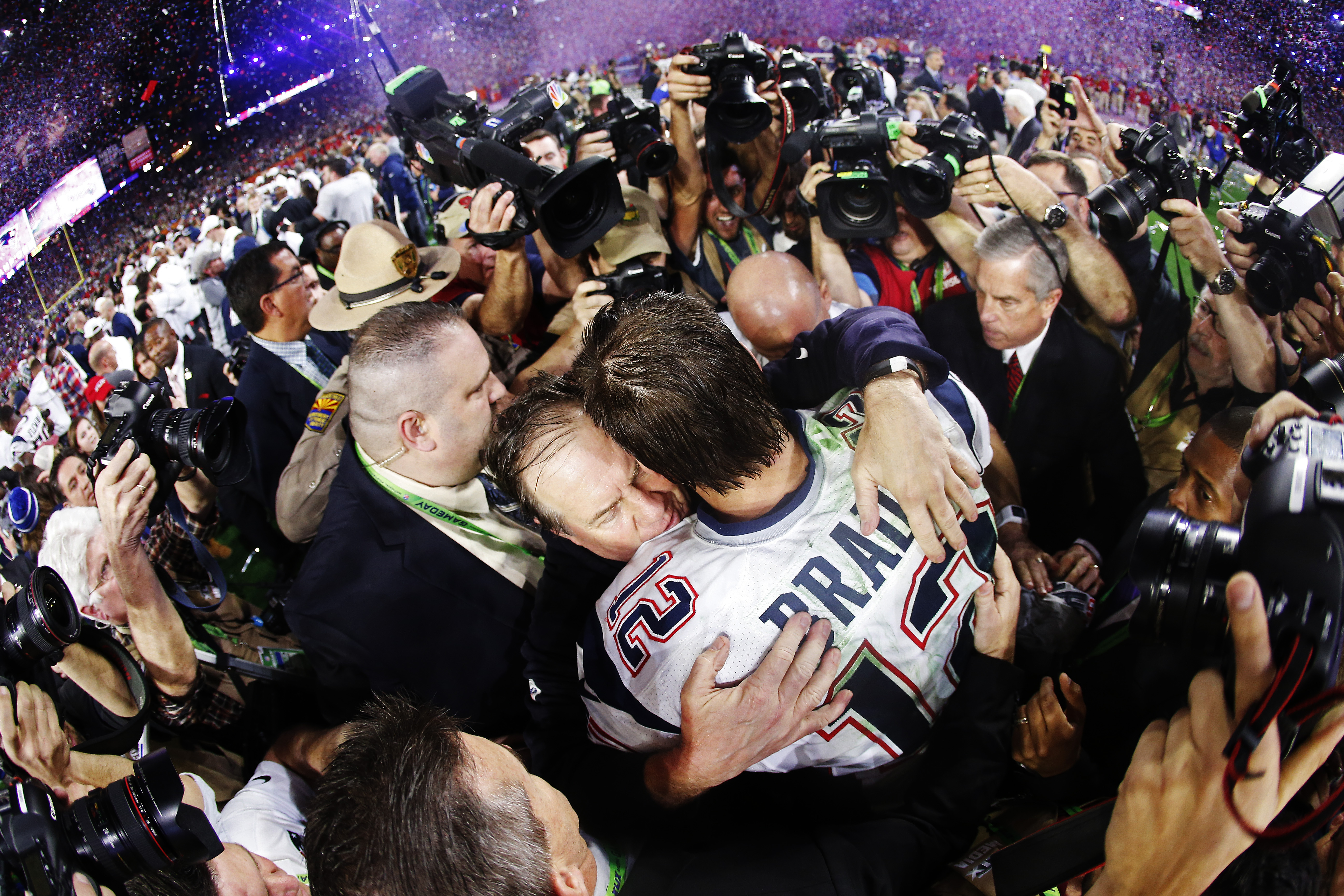 Tom Brady and Bill Belichick hug on the field after the victory.