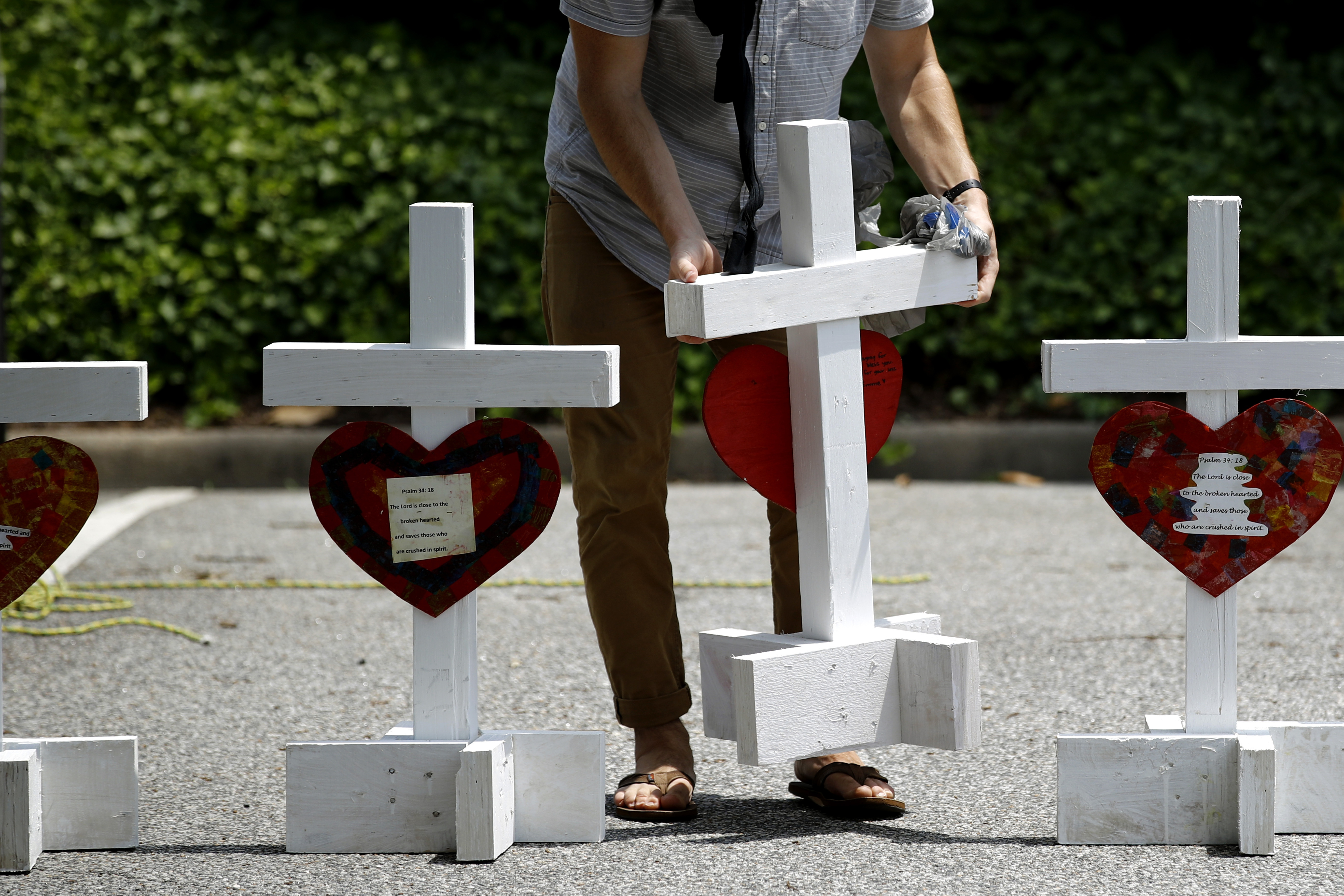A volunteer prepared to place crosses for victims of a mass shooting at a municipal building in Virginia Beach, Va., where 12 people died in June.