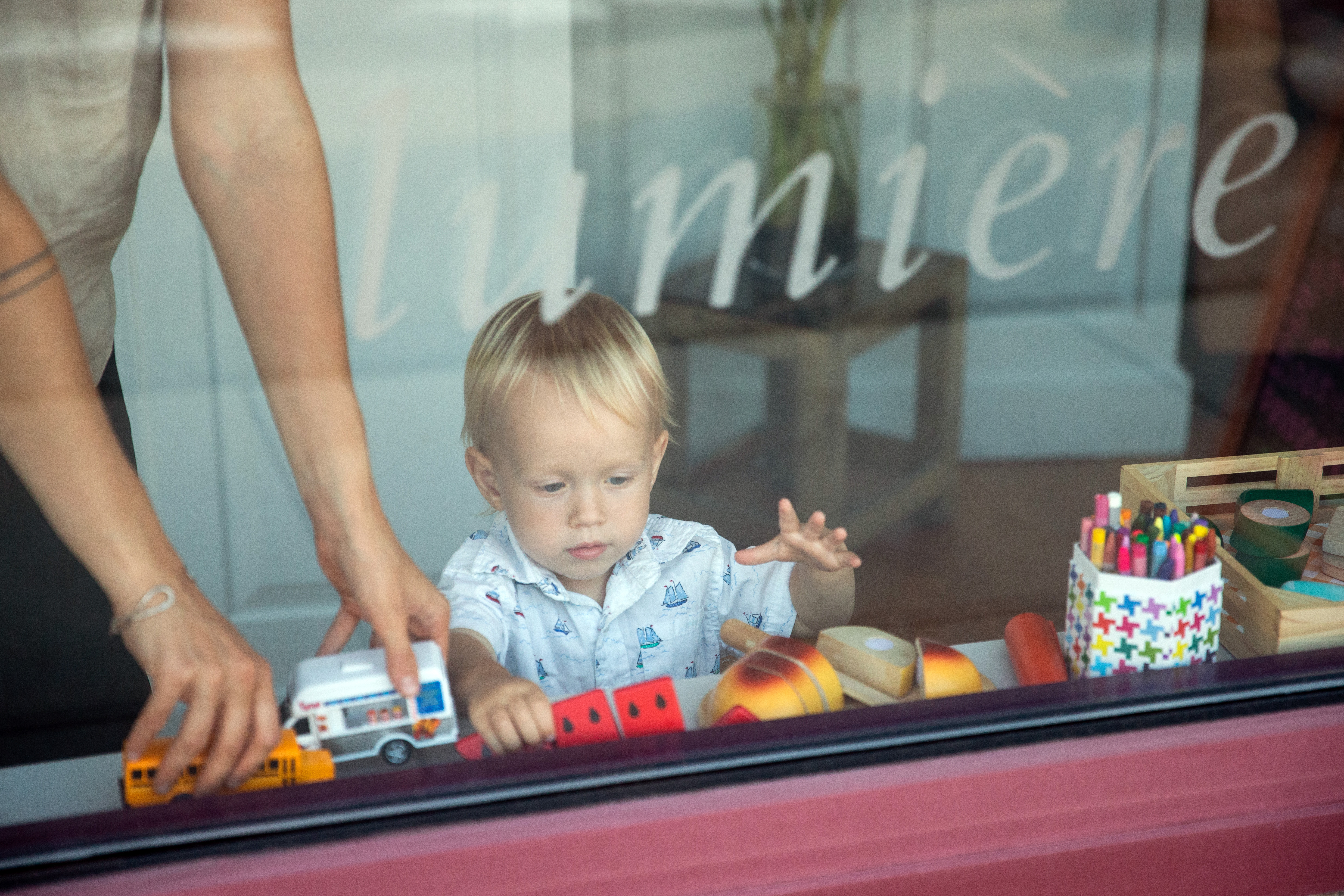 Anya helps her son as he picks out toys at Lumiere.