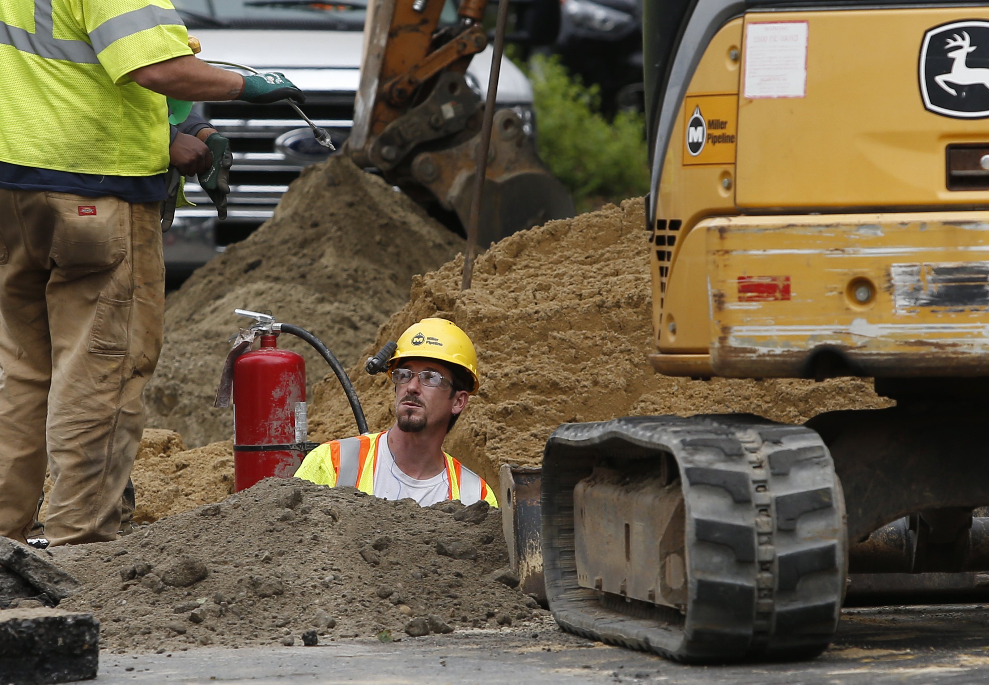 Gas line workers attempt to fix a pipe on Exeter Street in South Lawrence.