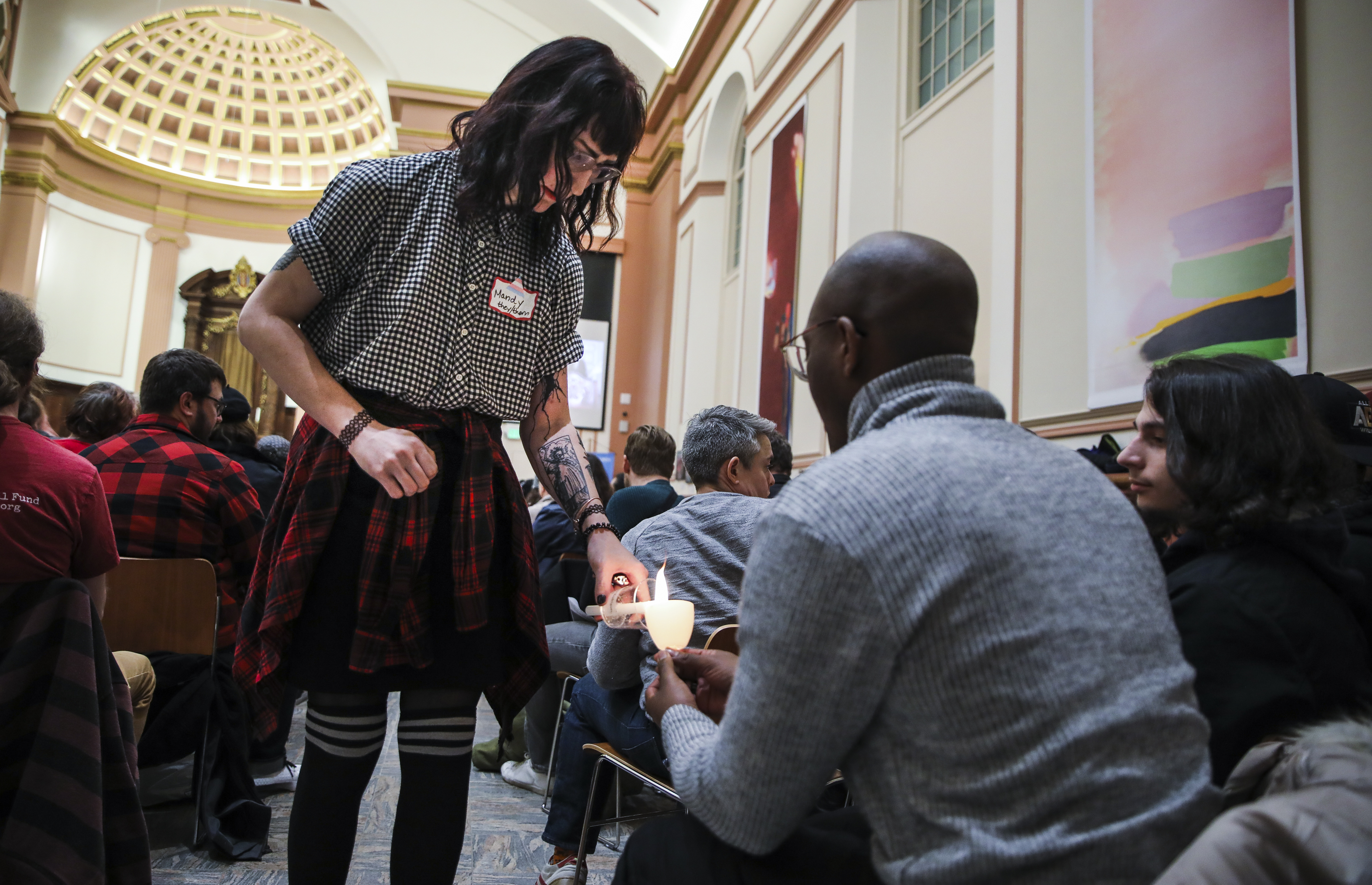 Mandy Wilkens, left, lit candles for audience members.