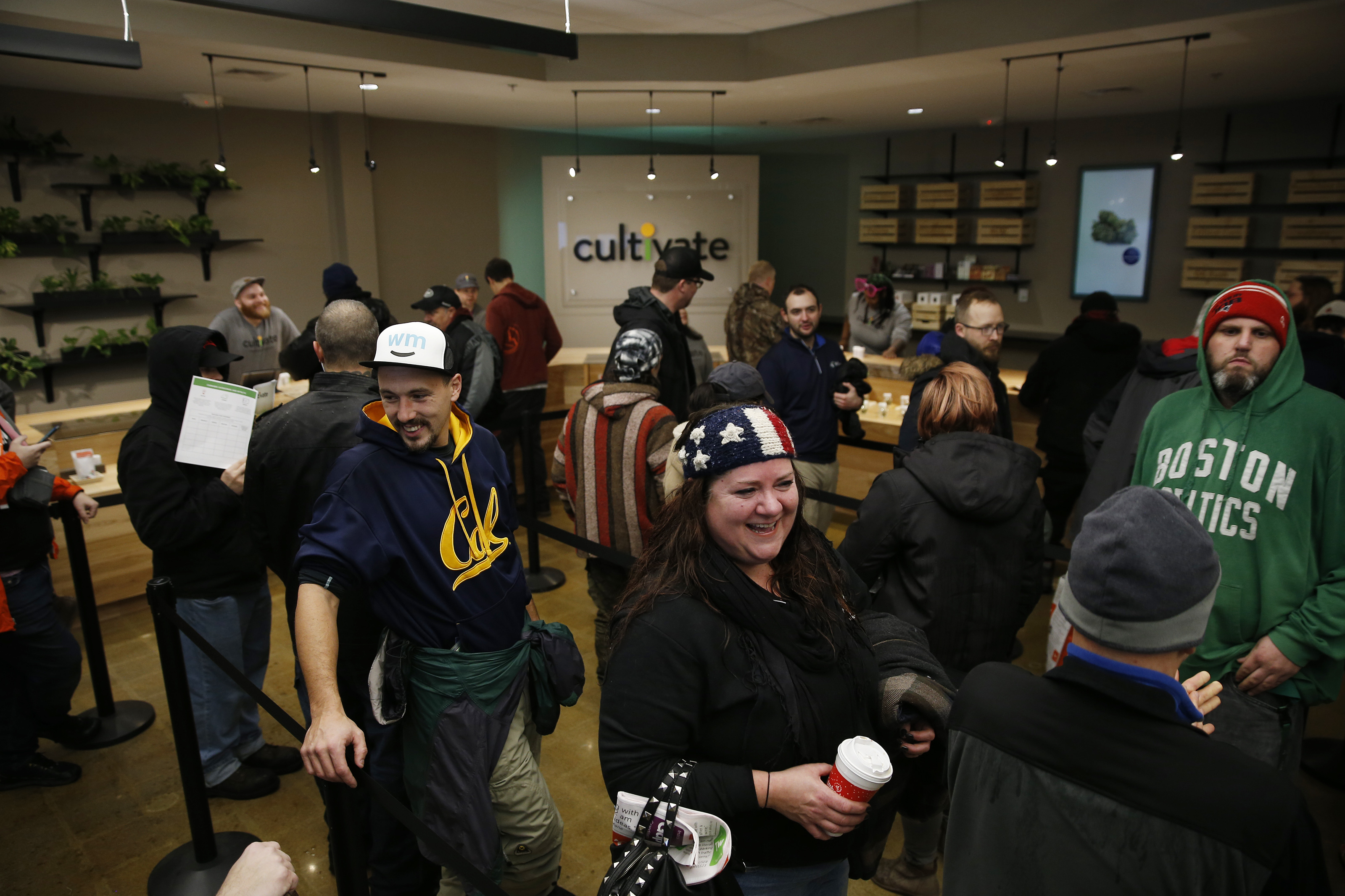 Jennifer DePerrio of Jefferson (center) laughed as she waits in line at the opening of Cultivate.