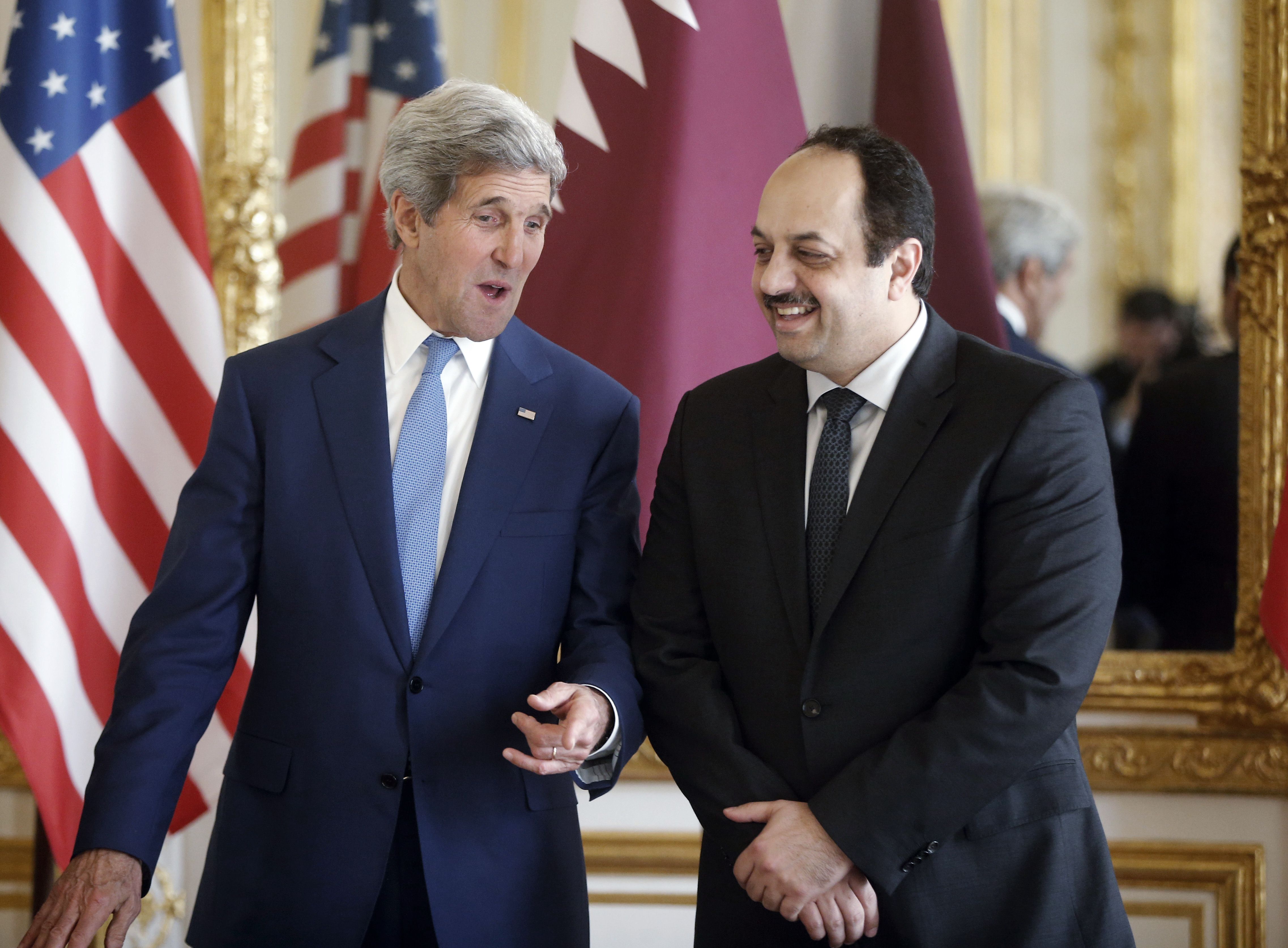Qatari Foreign Minister Khaled al-Attiyah (right) and Kerry spoke before a press conference in Paris on Saturday.