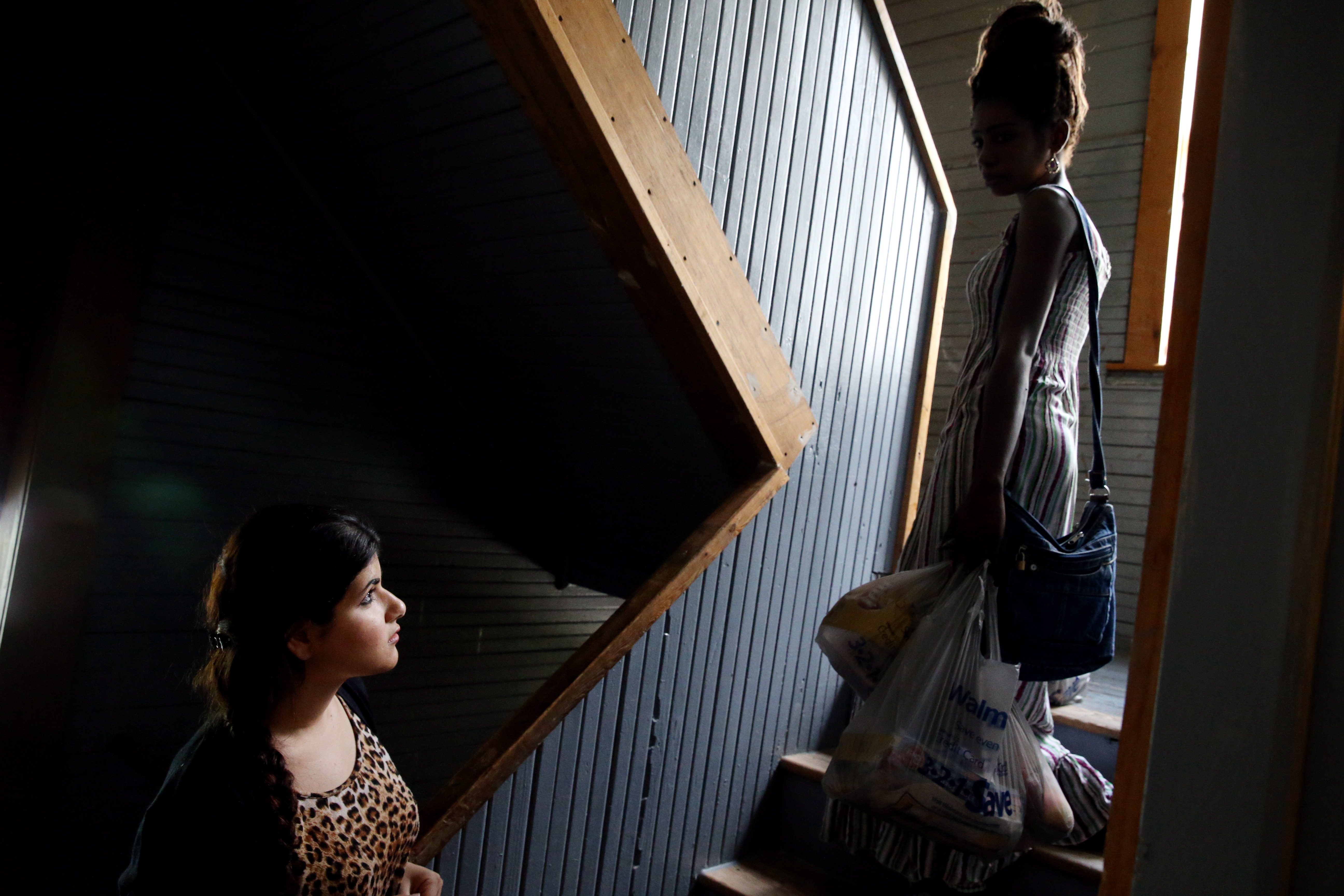 Sahar Kalmashy, left, spoke with a neighbor at her family’s home in Worcester.