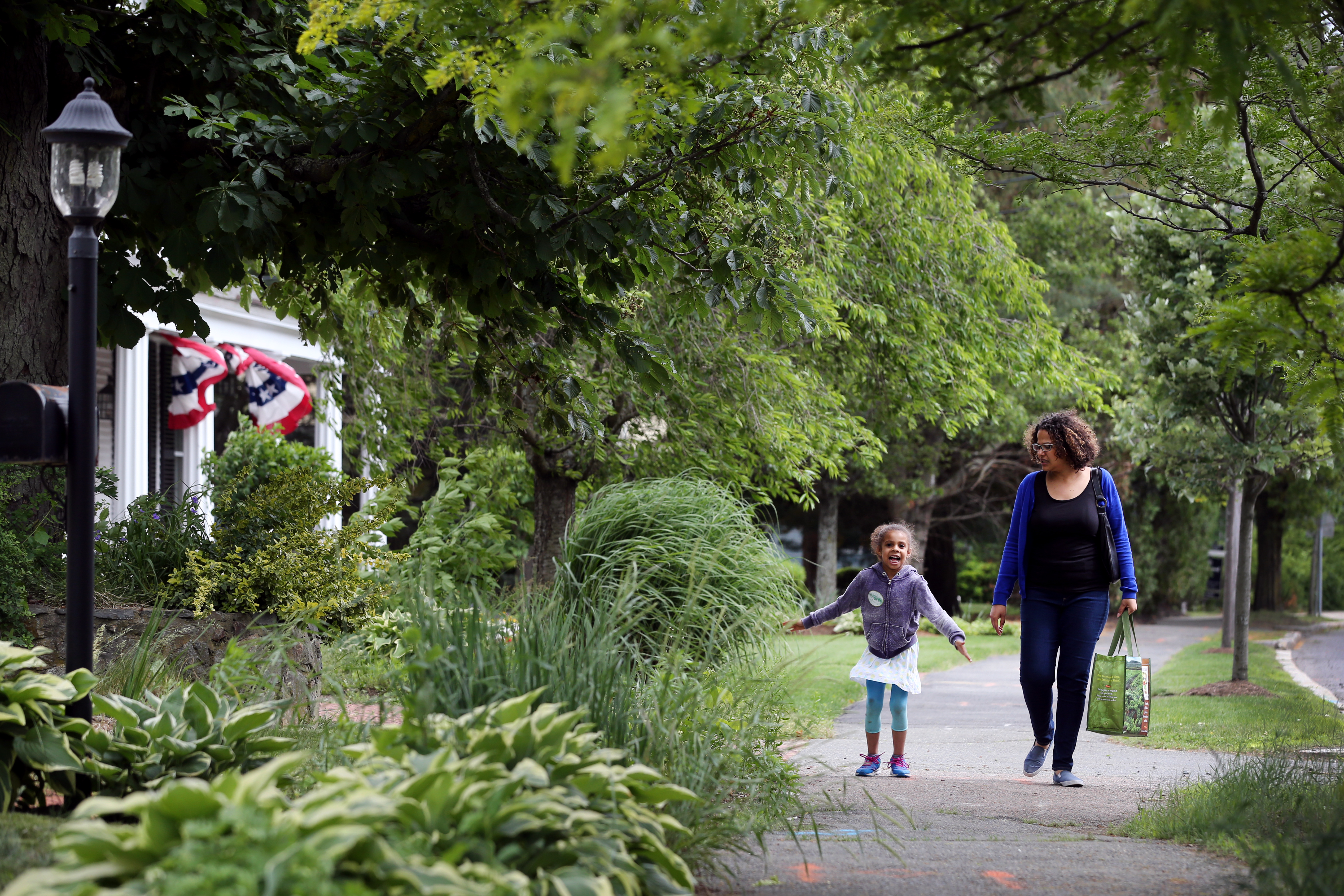 Evelyn Brito (top photo) and her daughter, Jalyn Brito Adams, 6, walked home after visiting a park and shopping at Wilson Farm in Lexington.