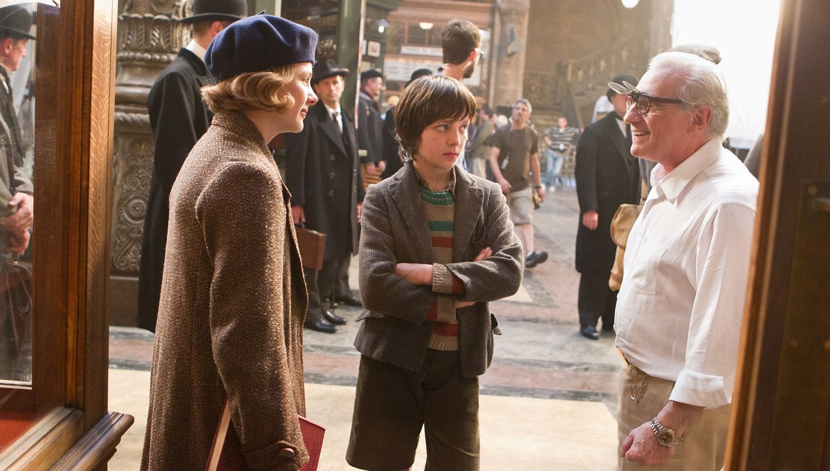 Chloë Grace Moretz (left) and Asa Butterfield talk with director Martin Scorsese on the set of “Hugo.’’
