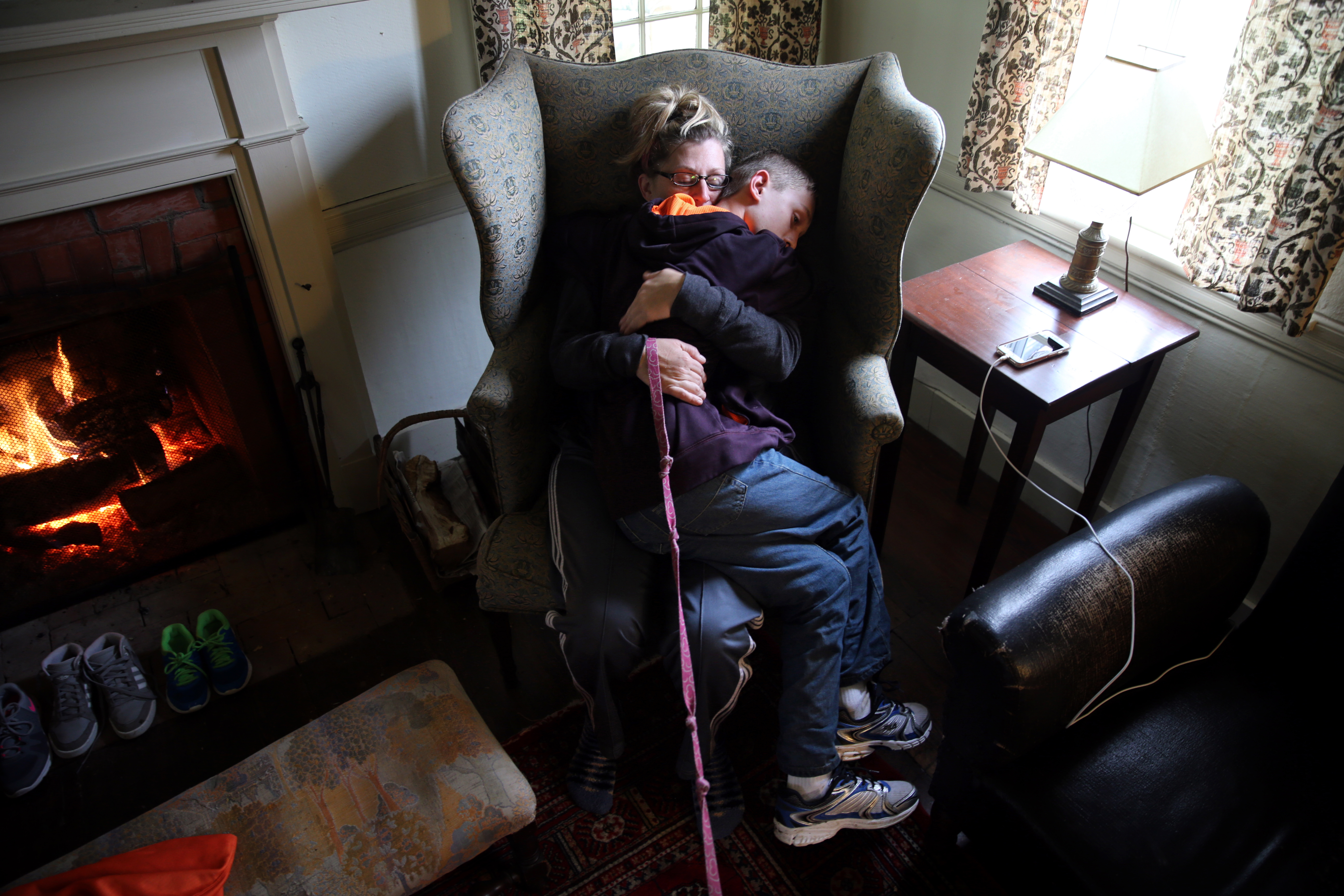 Roberta and Connor embraced while resting by the fire during a family gathering in Nelson, N.H. It had been a tough day. Connor struggles to manage his powerful reactions to disappointments, often taking out his anger on his mother.