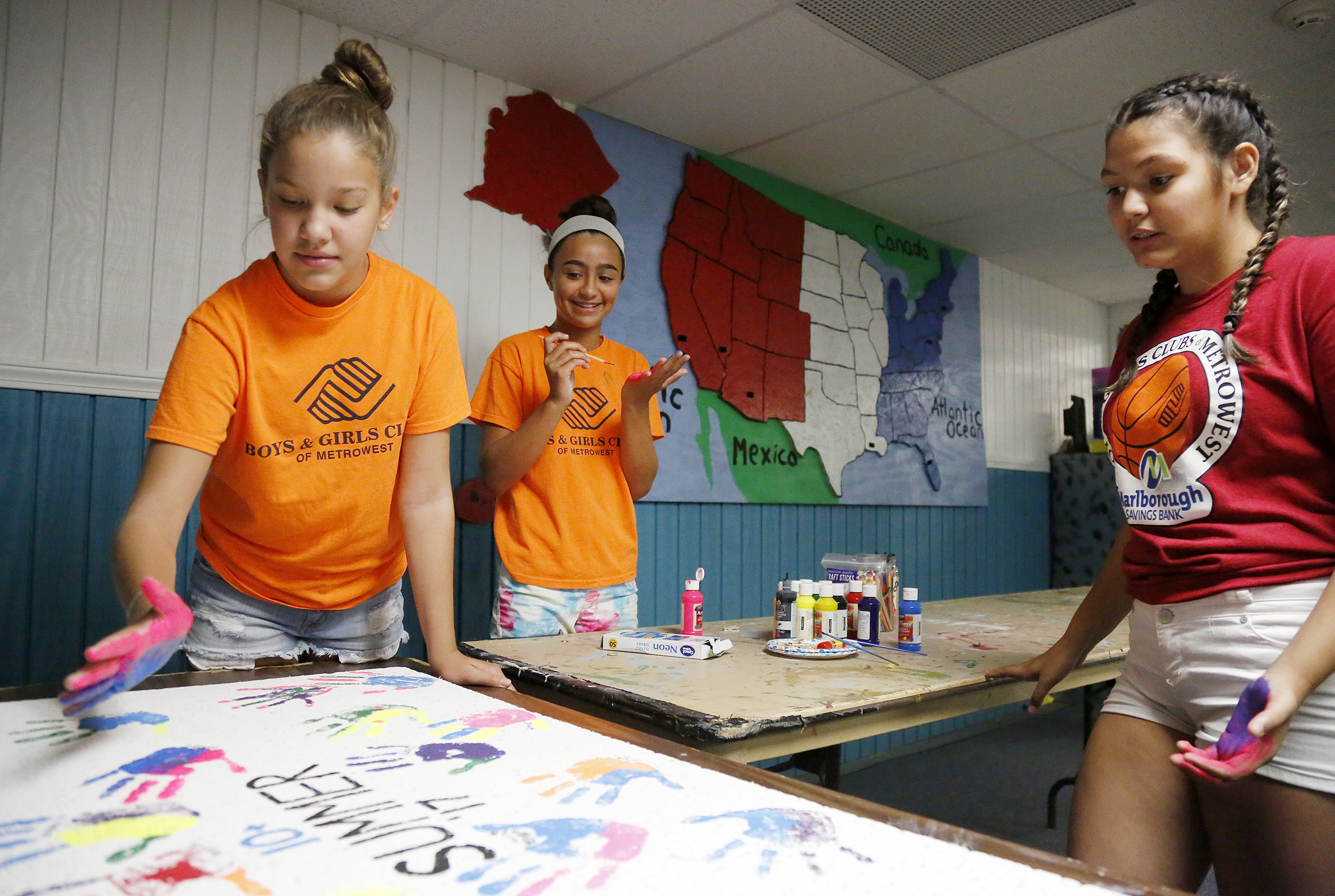 Gaby Tavares, 12, (left), Ashley Fasulo, 11, and Victoria Mier, 13, work on an art project at the Boys and Girls Club in Hudson.