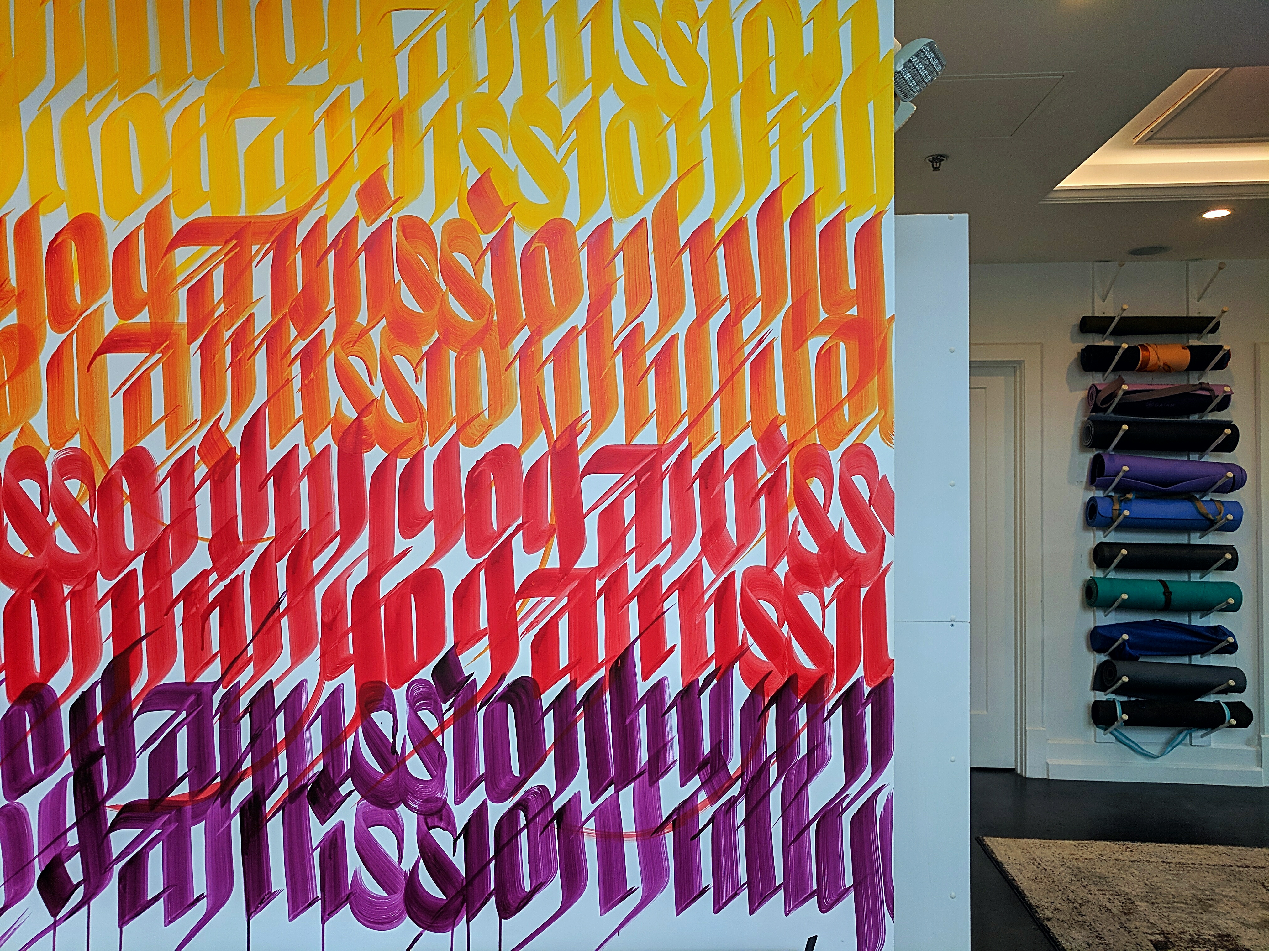 The entrance to Mission Hill Yoga is emblazoned with a colorful mural by the artist Sneha Shrestha, known as Imagine.