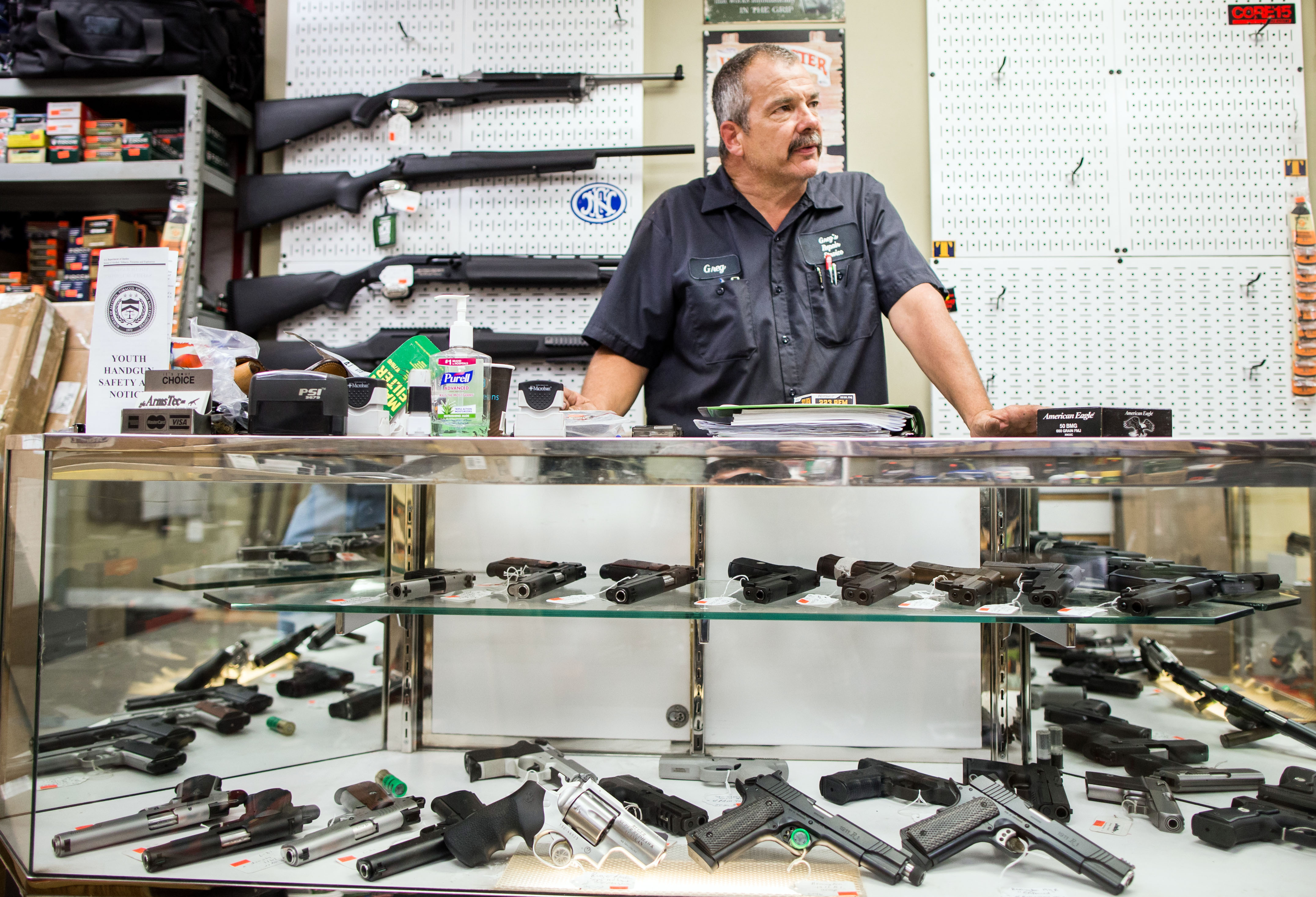 Owner Greg Malany helped customers at GFA Arms Tec in Natick.